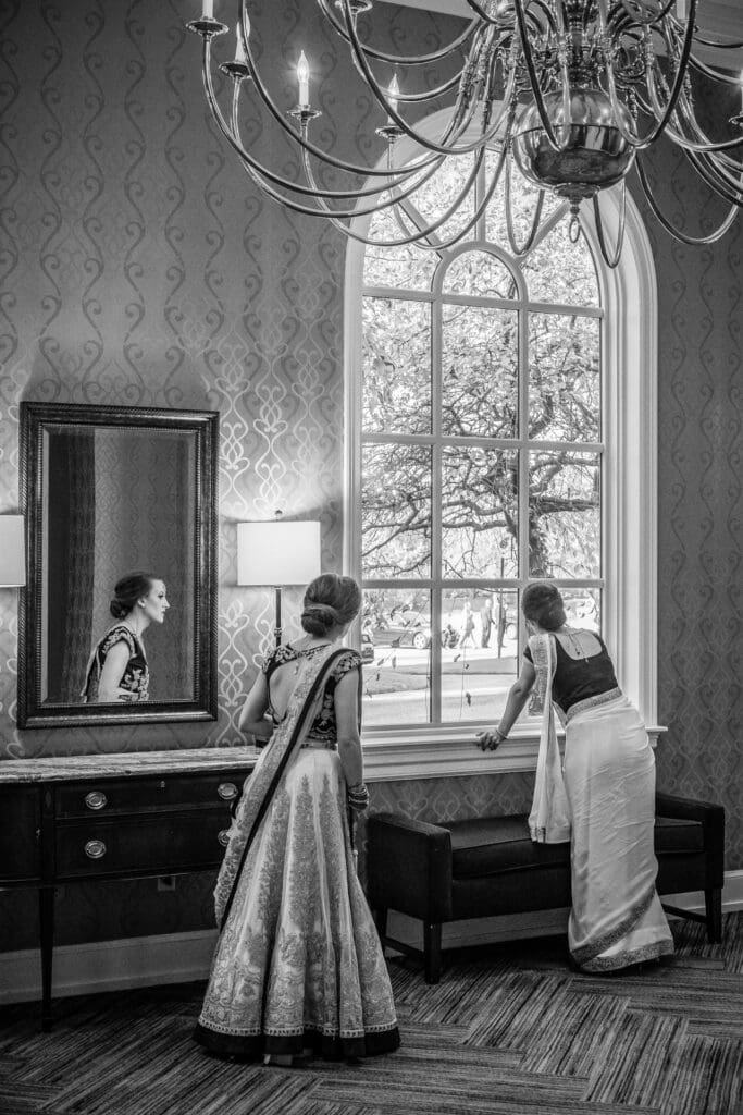 Quiet wedding morning moment as family members look out the window together