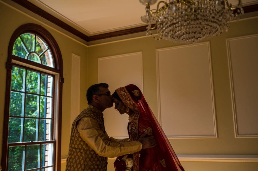 Emotional wedding moment as family member shares a quiet embrace with the bride