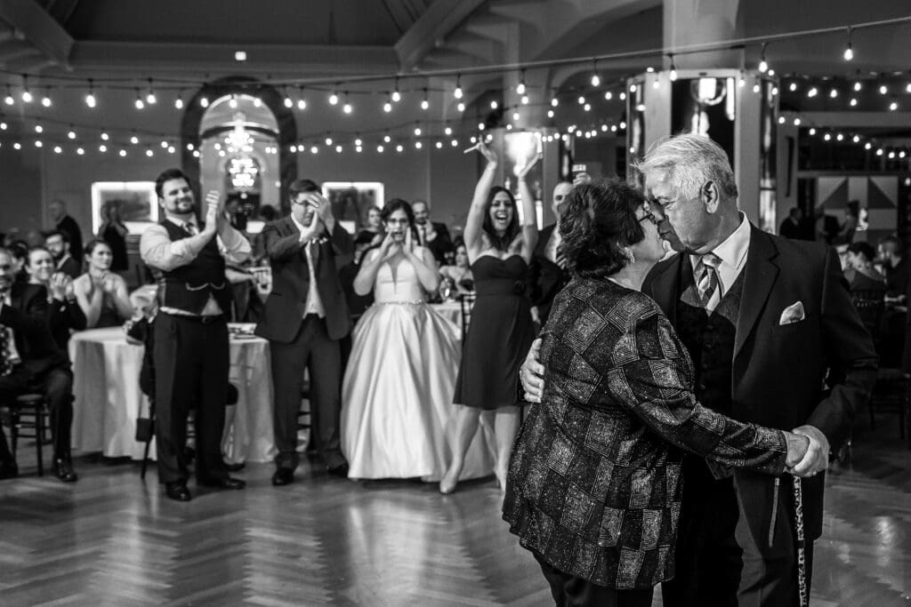 Generational wedding moment as an elderly couple dances during the reception