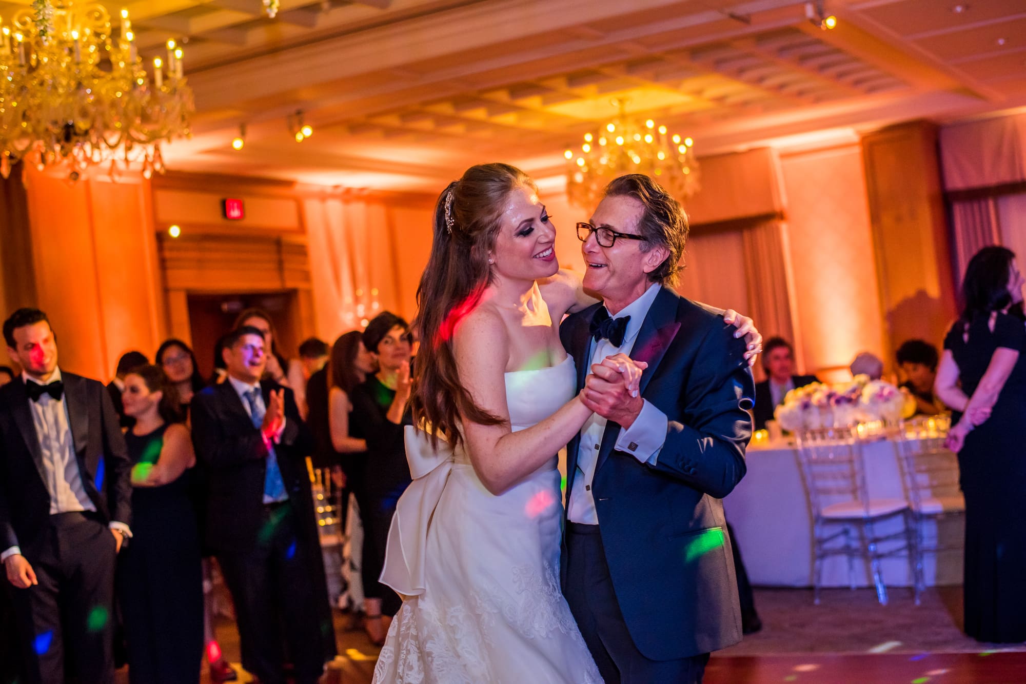 Bride adjusting dress near window light
