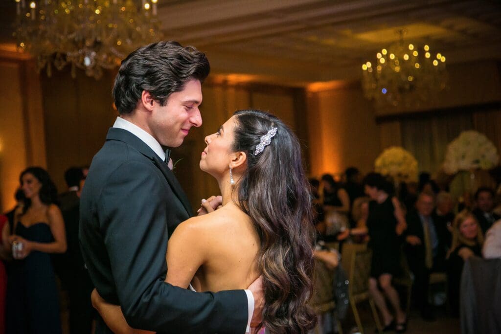Couple sharing an intimate moment during wedding reception.