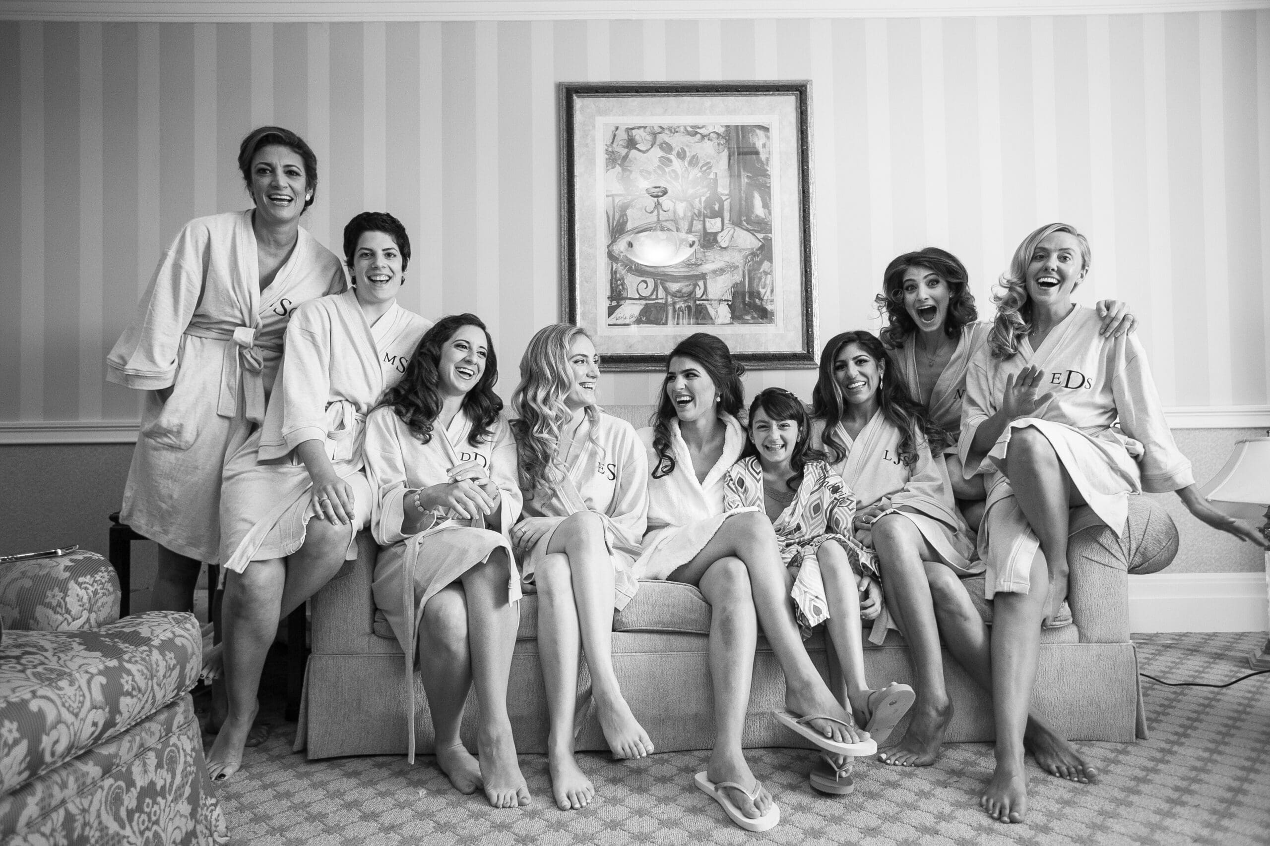 Bridal party laughing together while getting ready.