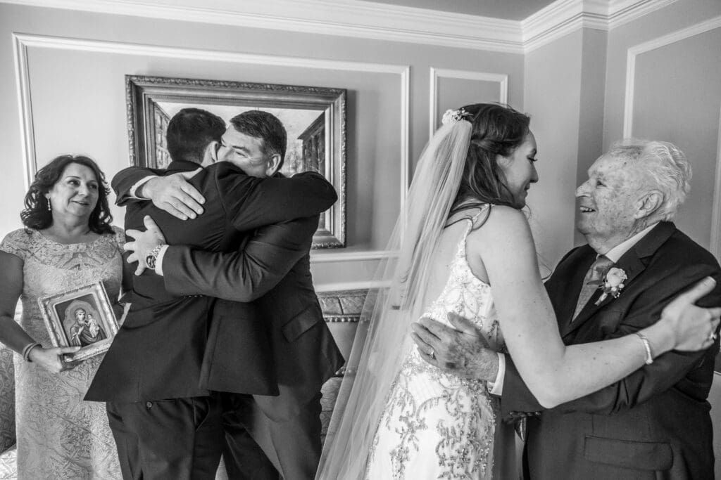Emotional wedding day moment as family members embrace before the ceremony
