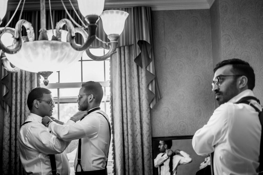 Groom getting ready with groomsmen during the wedding morning