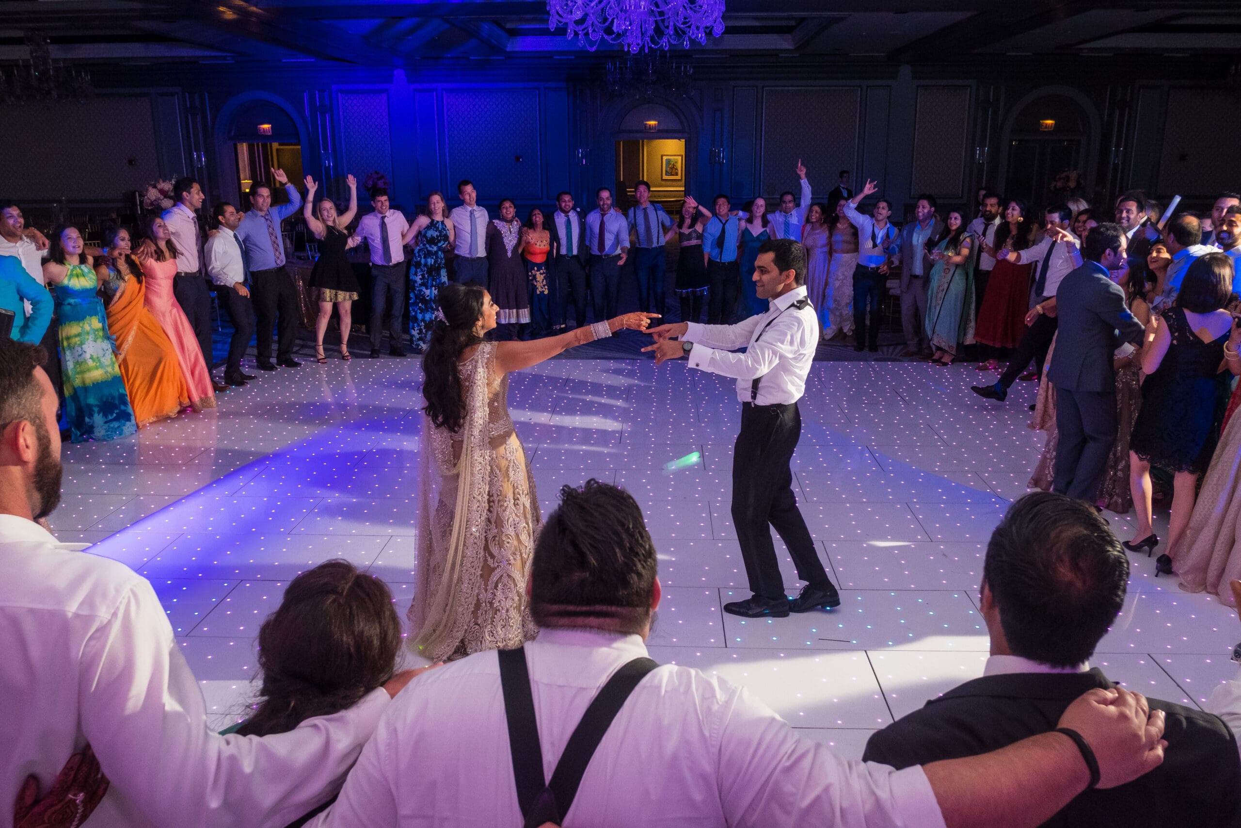 Wedding guests dancing during vibrant Indian reception