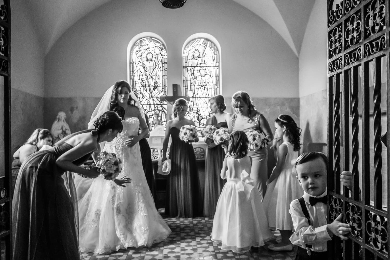 ring bearer standing with groomsmen during the ceremony