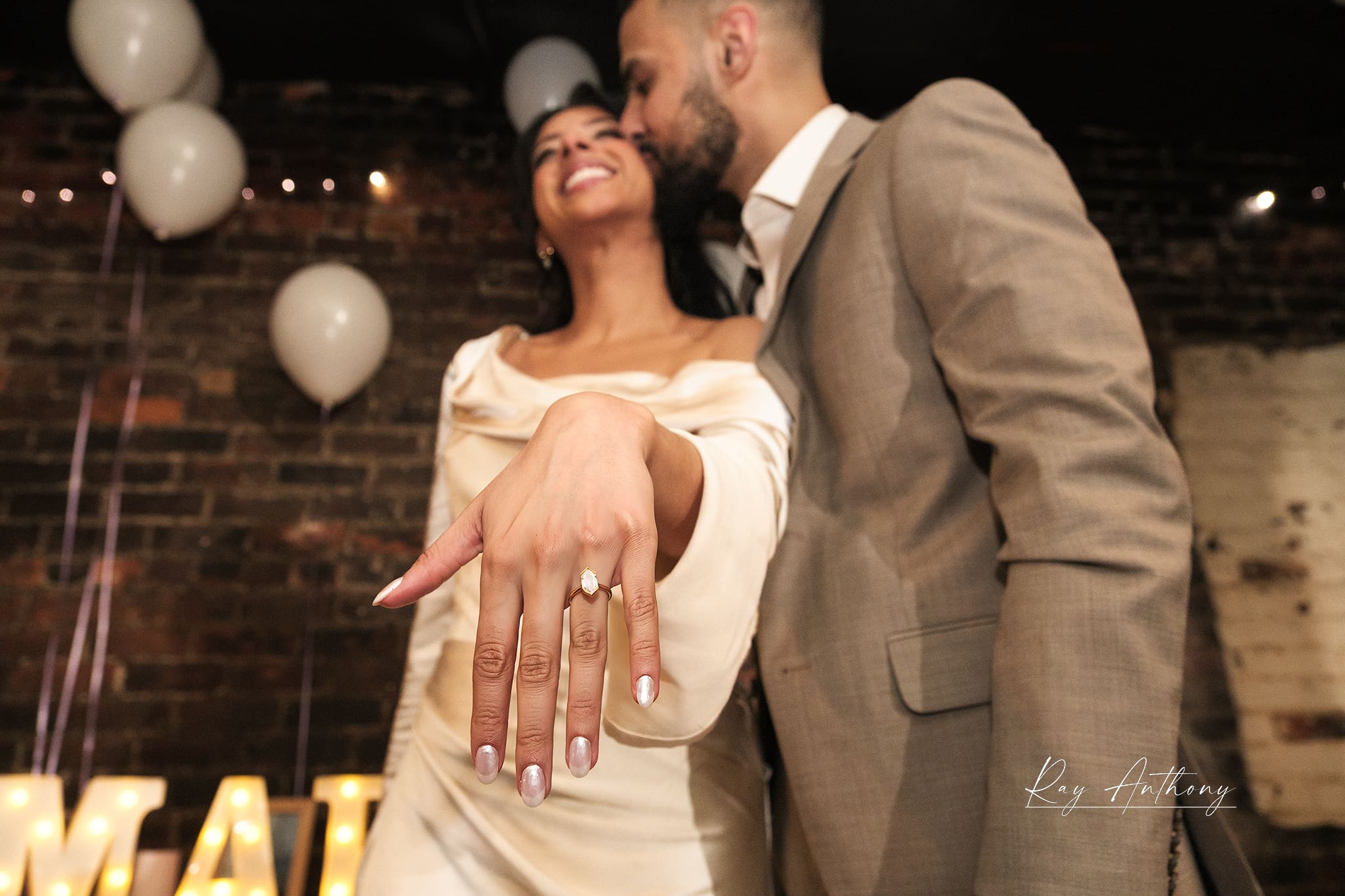 couple walking across downtown Detroit street holding hands