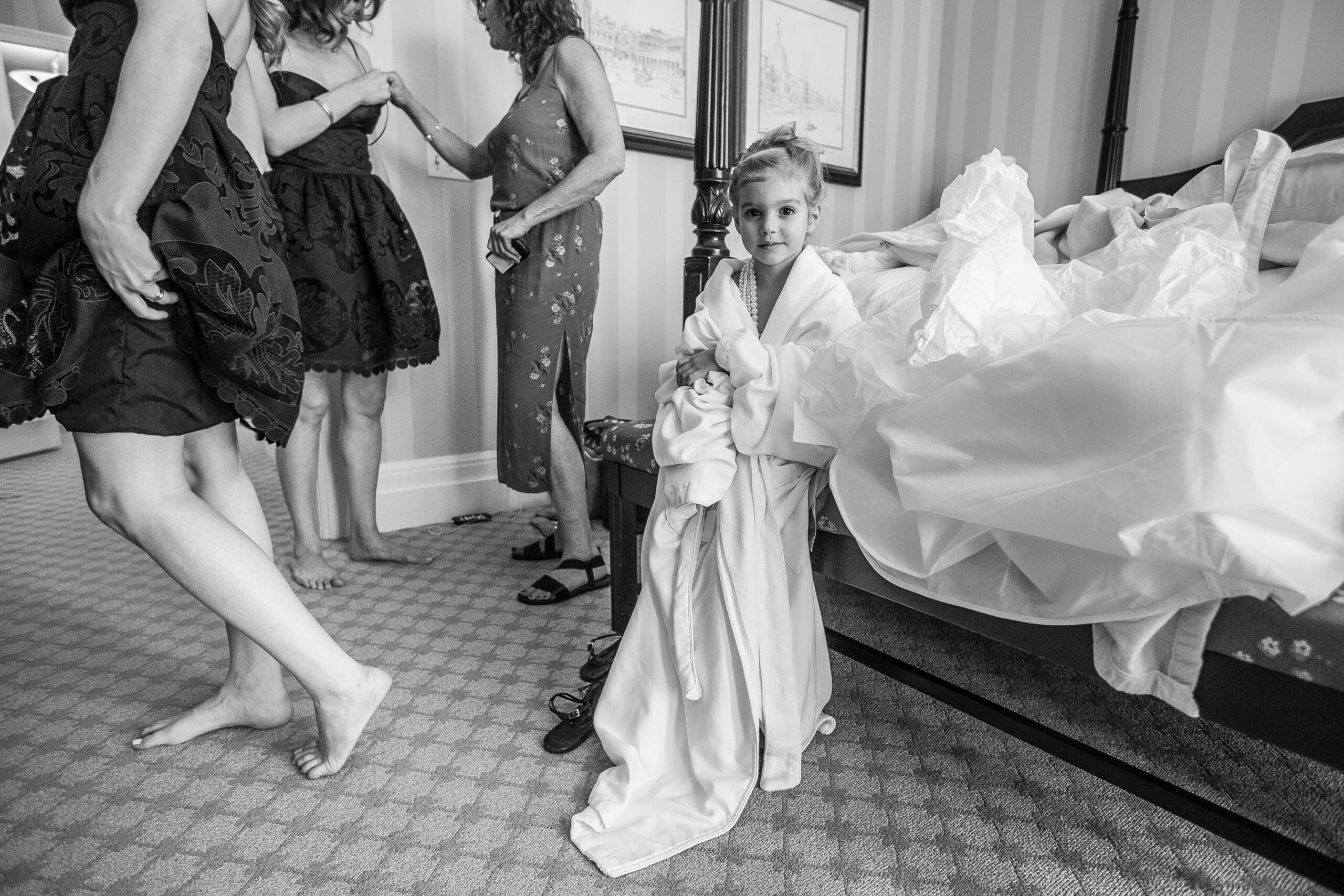 flower girl resting during a summer wedding ceremony