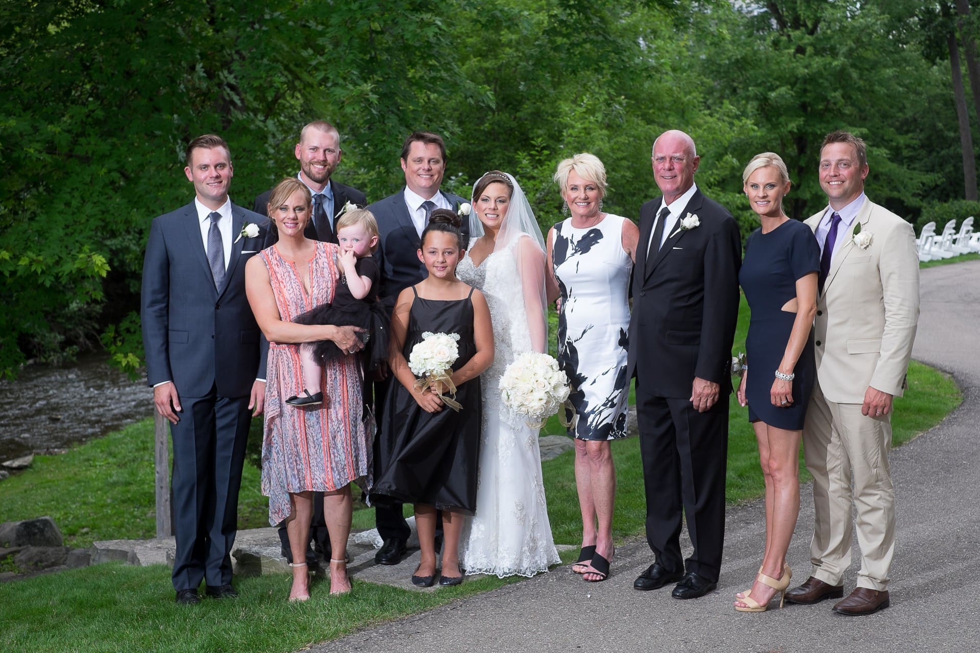 Family members posing together for a wedding portrait outdoors.
