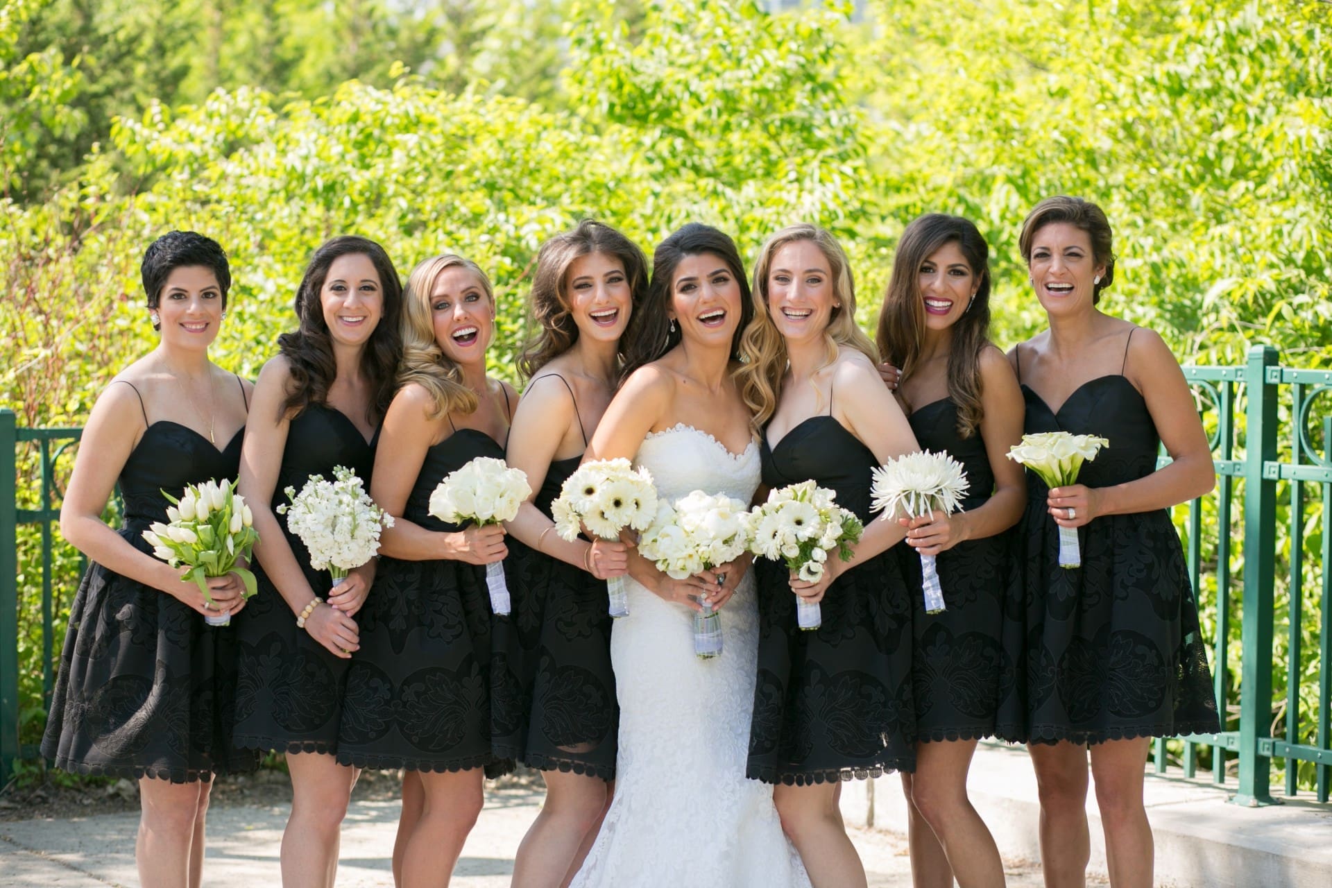 Bride and bridesmaids posing together before the wedding ceremony.