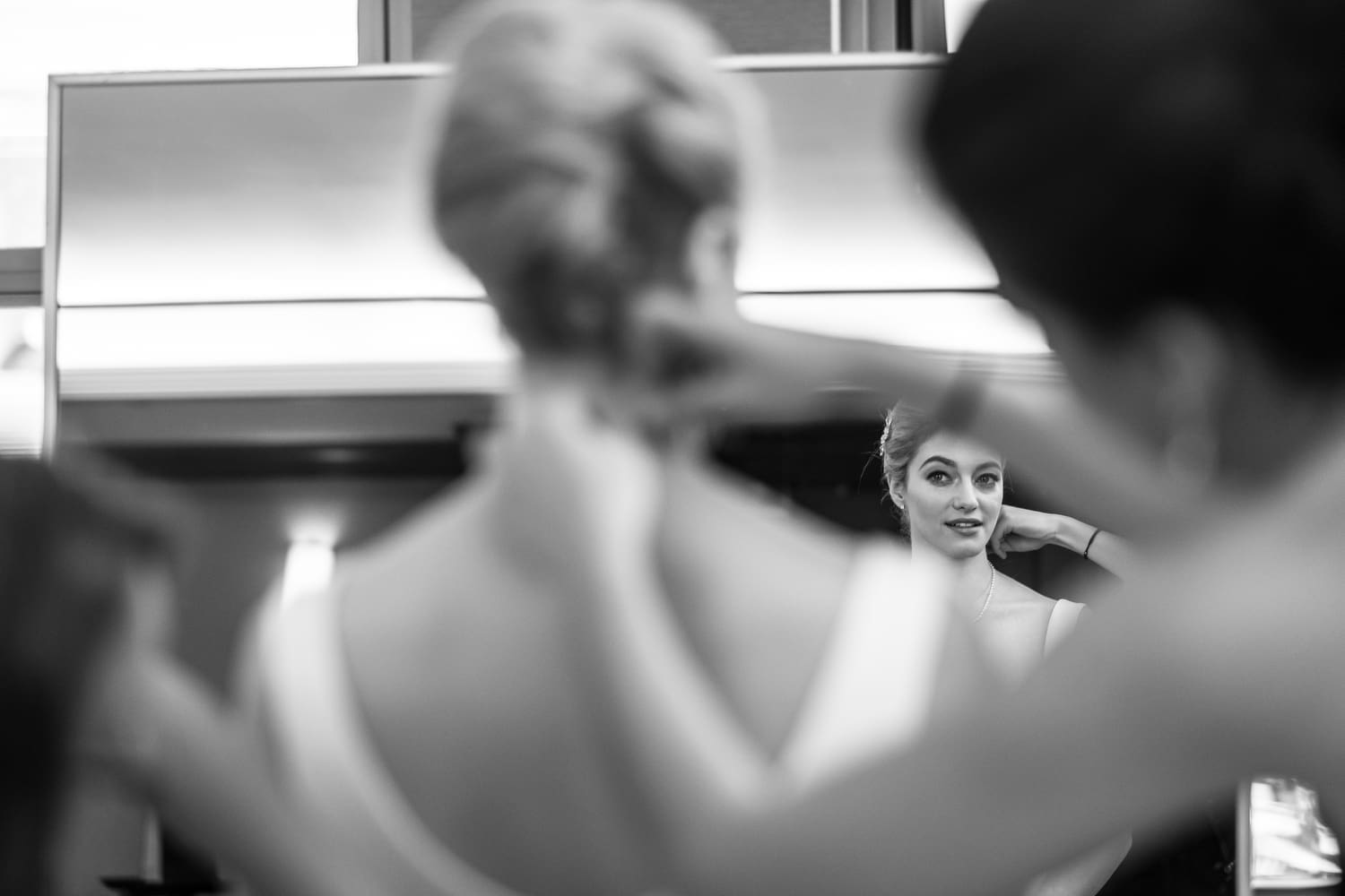 Bride getting ready with assistance before her wedding ceremony.