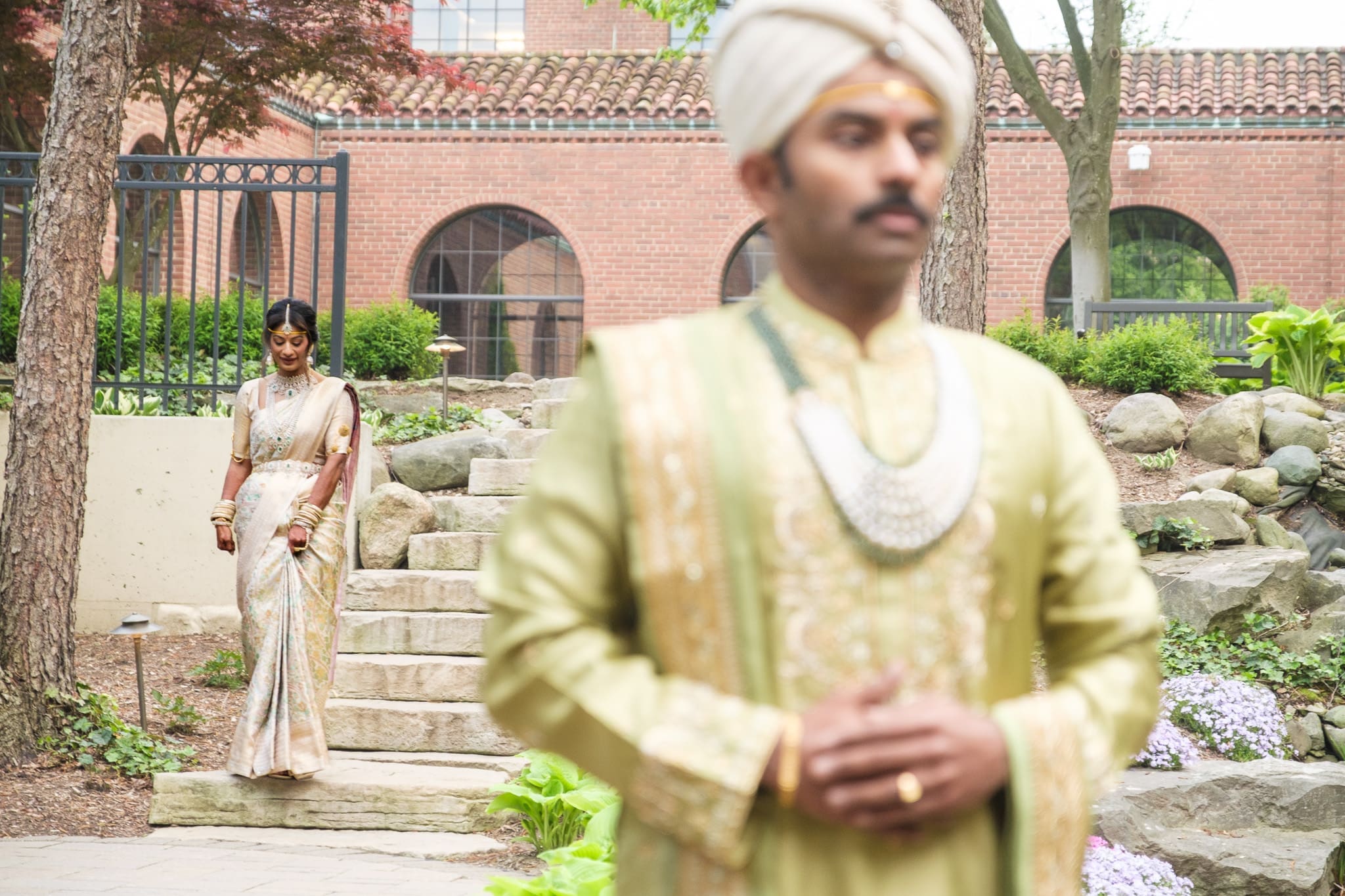 Bride and groom sharing a quiet moment before their South Asian wedding ceremony.