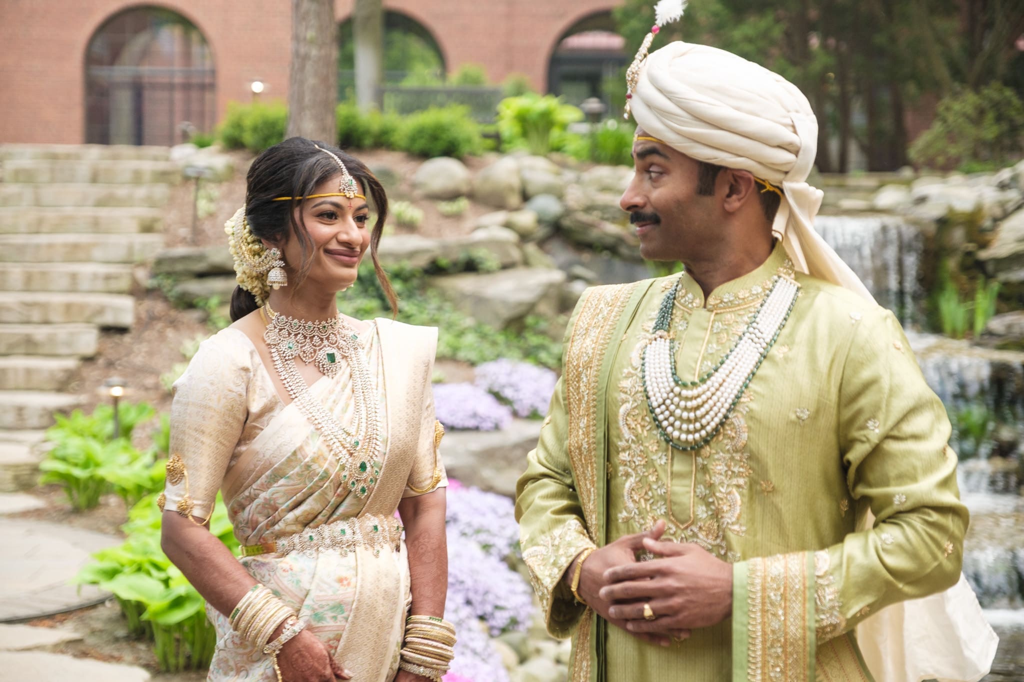 South Asian bride and groom sharing a candid moment before their wedding ceremony.