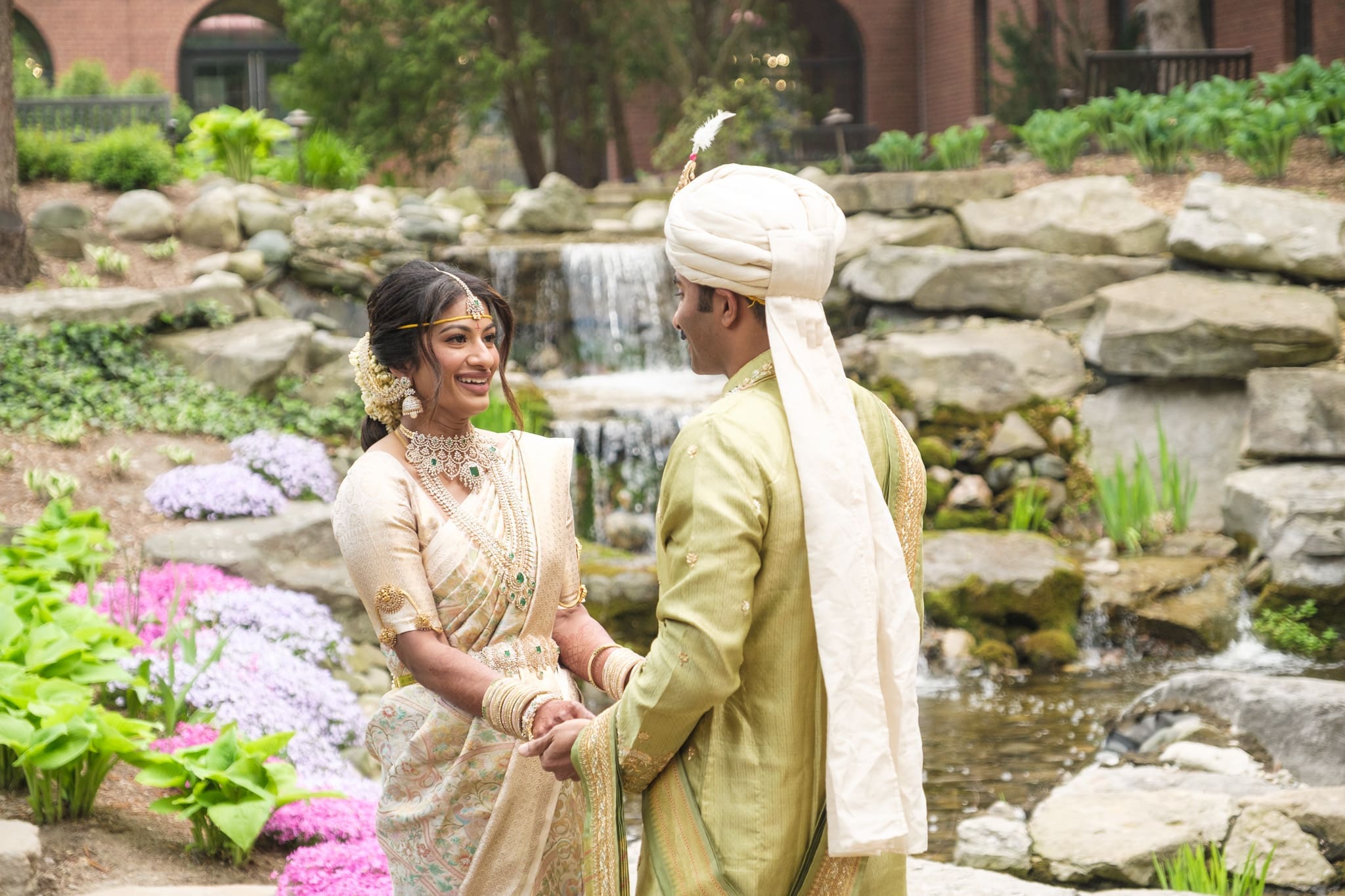 South Asian bride and groom walking together during their wedding portrait session.