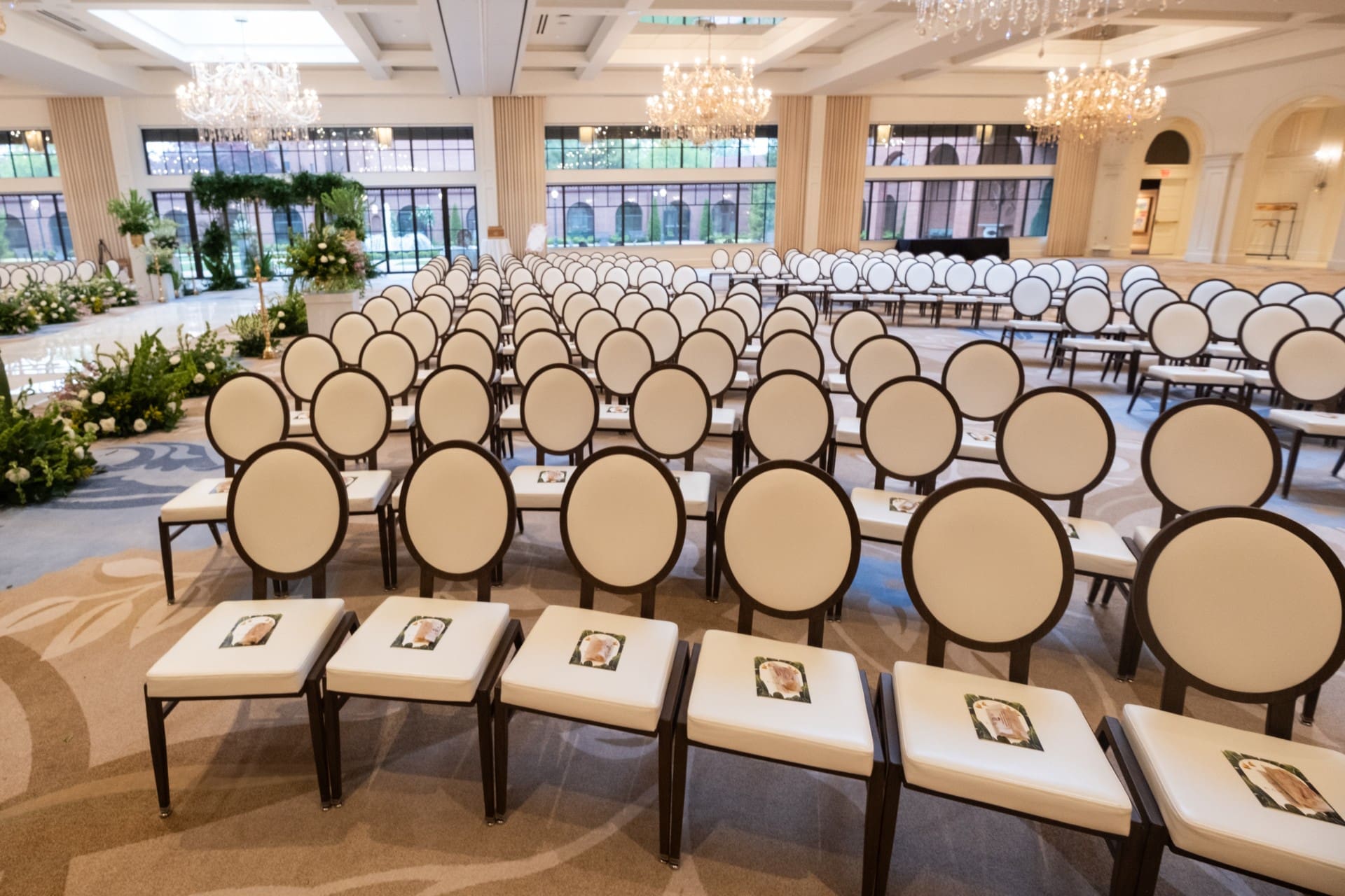 Wedding guest seating inside Monarch Ballroom at Saint John's Resort arranged for a large ceremony, featuring elegant chairs, crystal chandeliers, and a spacious ballroom layout.