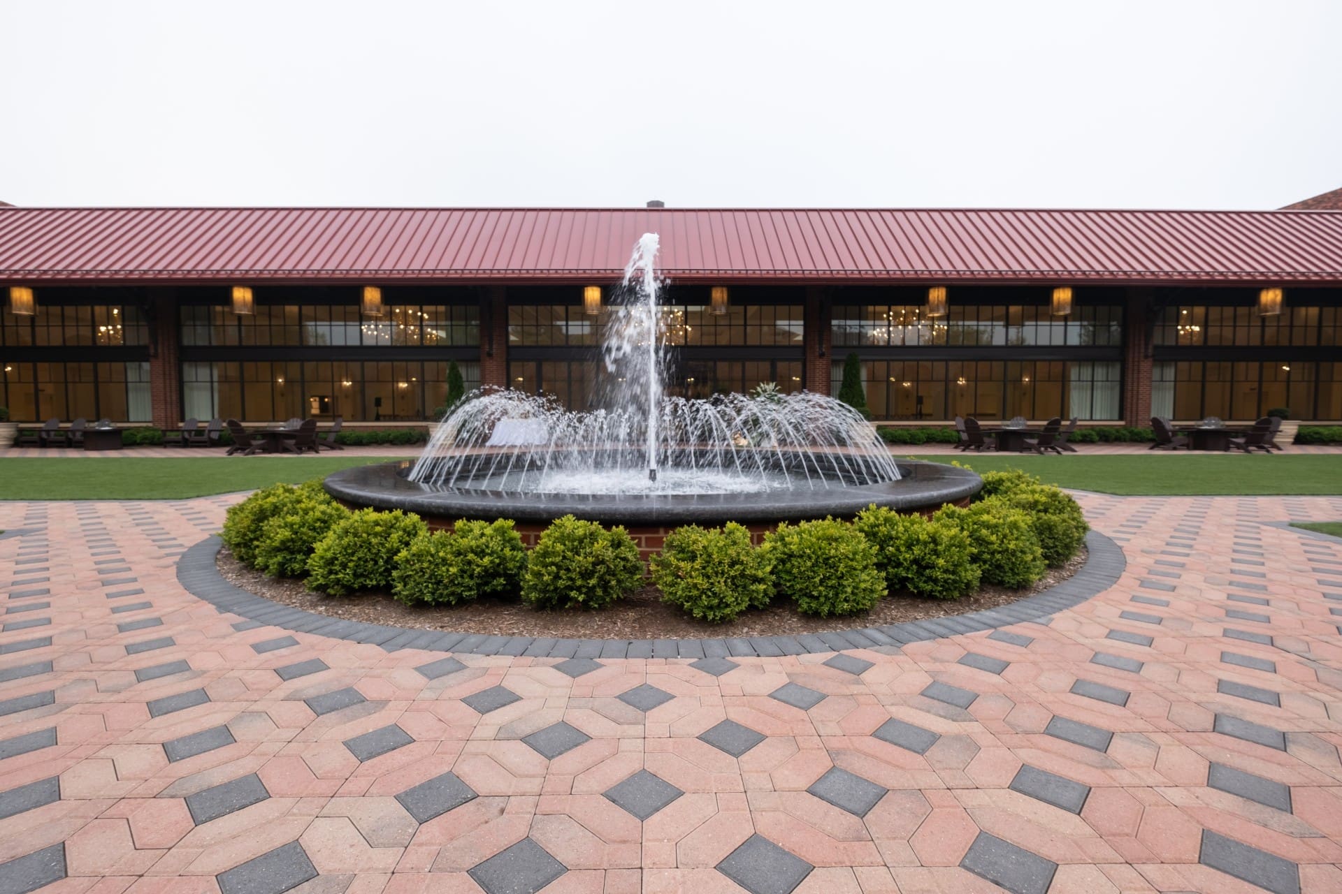 Landscaped fountain courtyard at Saint John's Resort featuring brick walkways, outdoor gathering space, and elegant resort architecture.