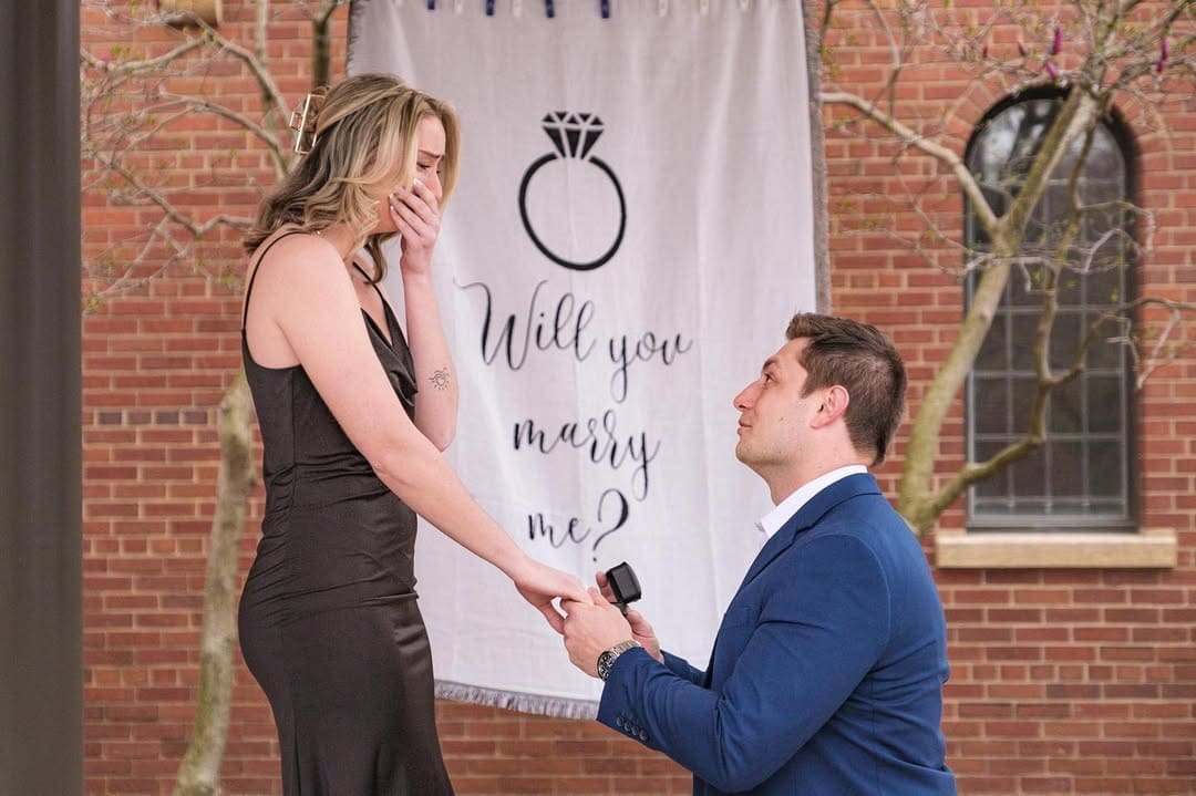 Couple dressed in stylish outfits during a Detroit engagement and proposal photo session.