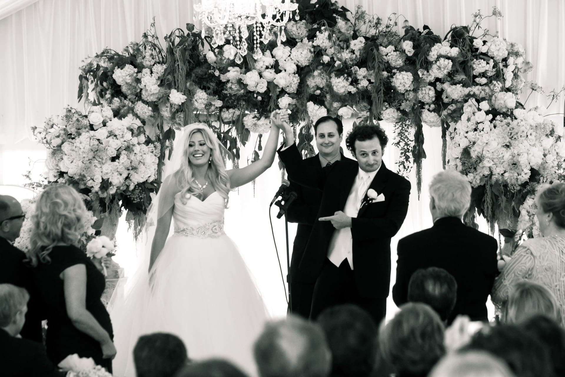 Bride and groom celebrating with family and friends during their wedding ceremony.