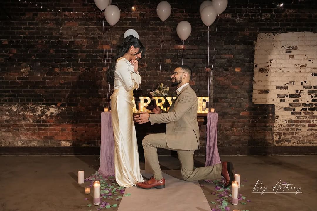 Couple wearing coordinated outfits during a romantic Detroit proposal photo session.