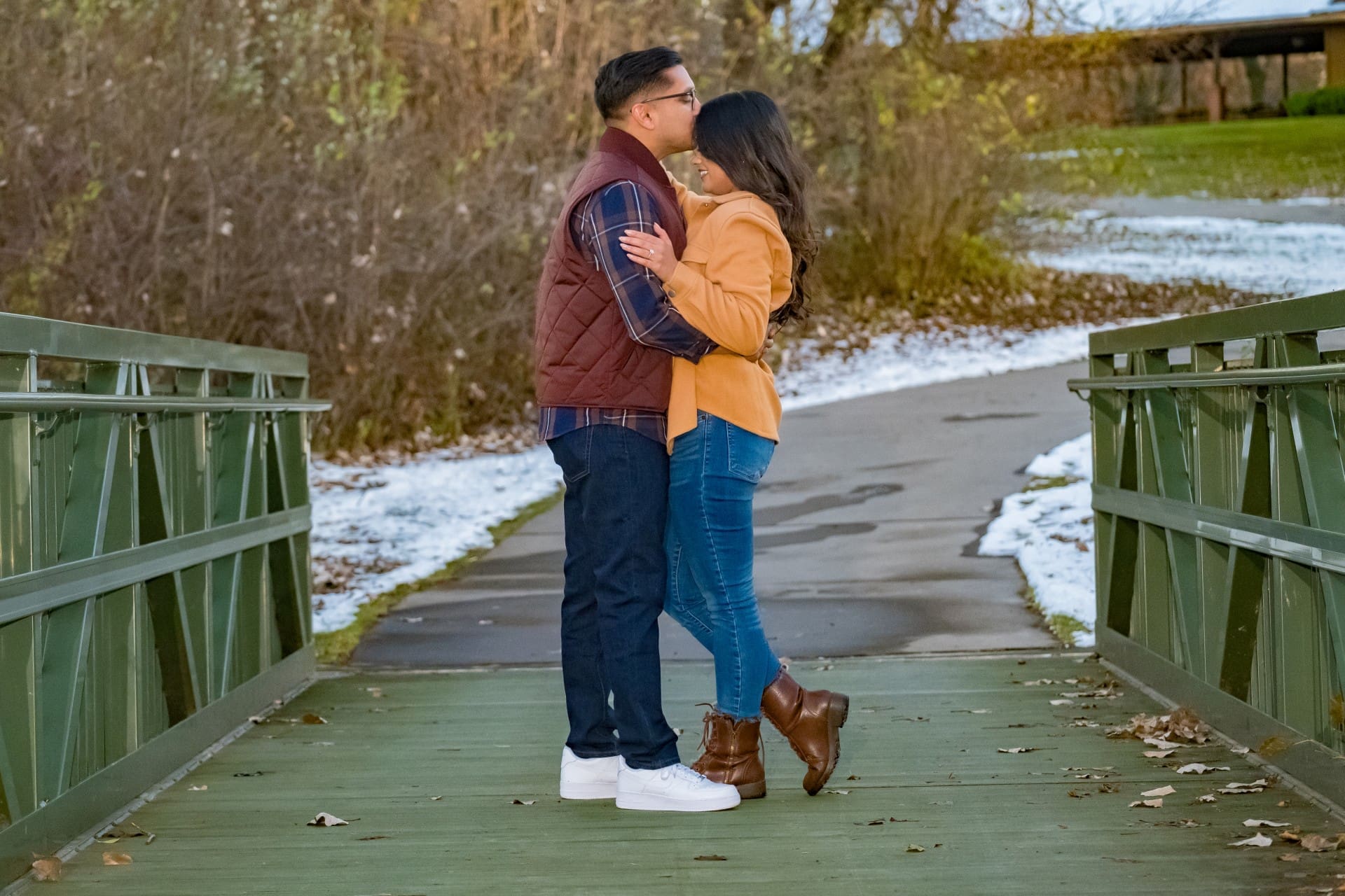 Couple embracing on a bridge during downtown Detroit engagement photos.