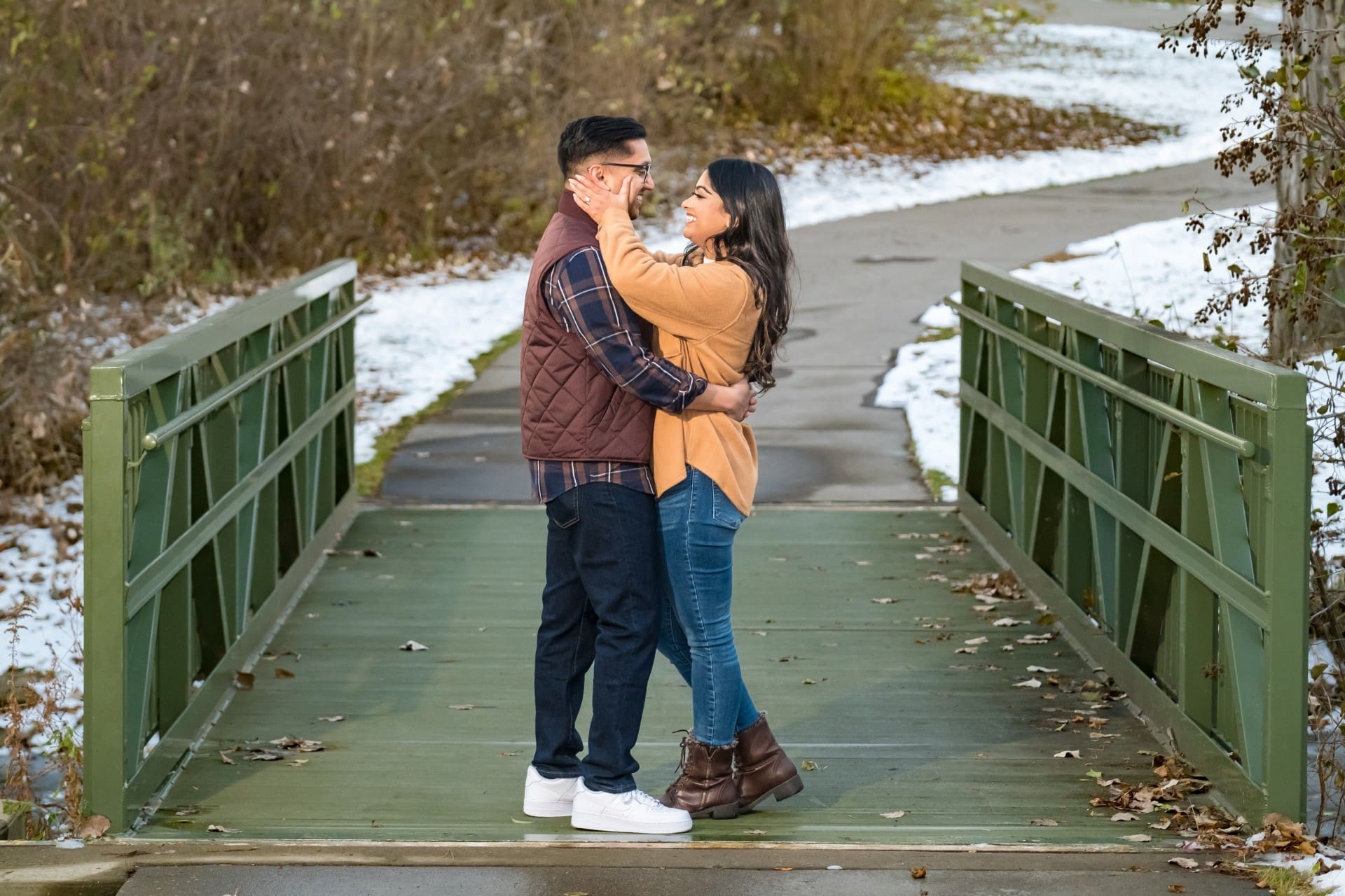 Couple sharing a romantic embrace during an outdoor engagement session in Detroit.