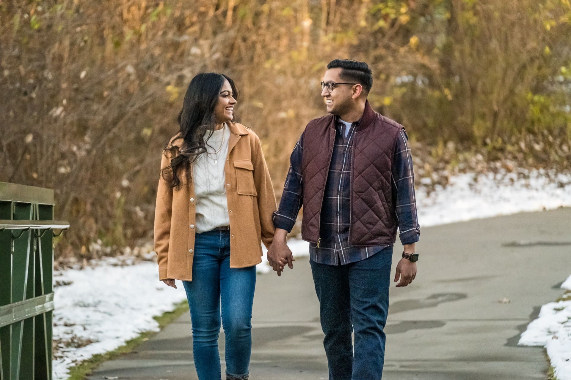 Couple walking together during a romantic engagement session in Detroit.