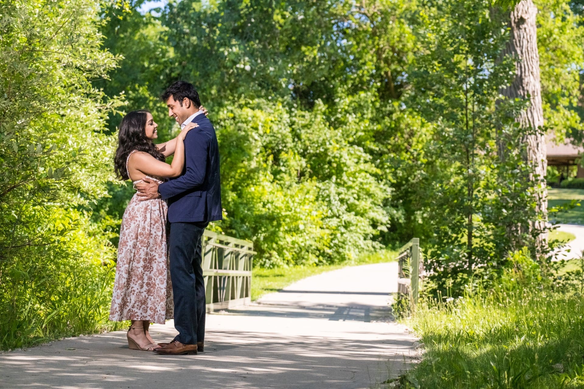 Couple sharing a romantic embrace during an outdoor engagement portrait.