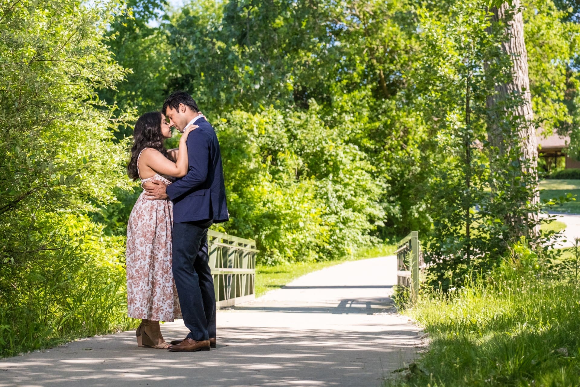 Couple embracing beneath the trees during a romantic Detroit engagement shoot.