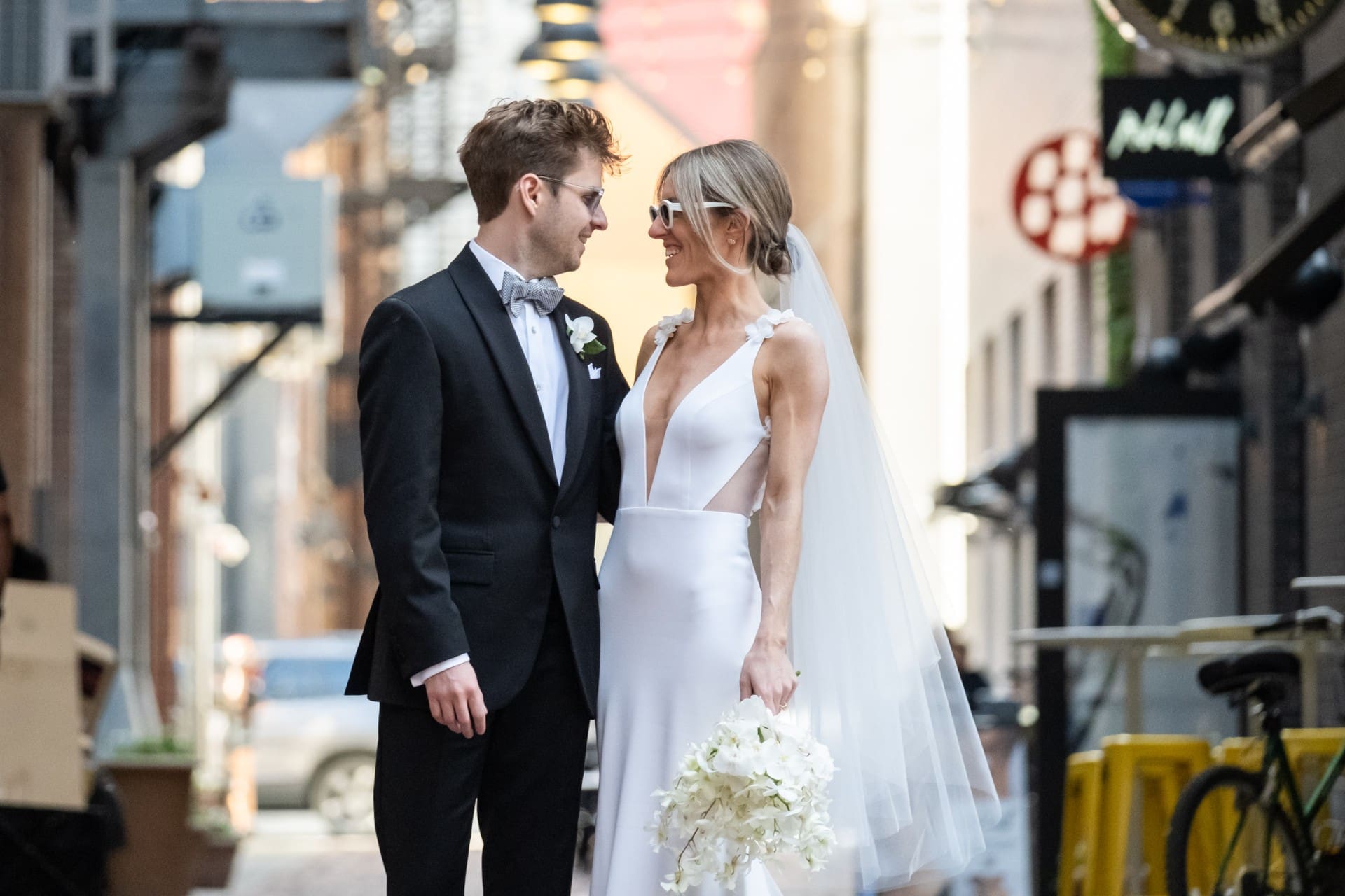 Bride and groom sharing a joyful moment during a downtown Detroit wedding portrait.
