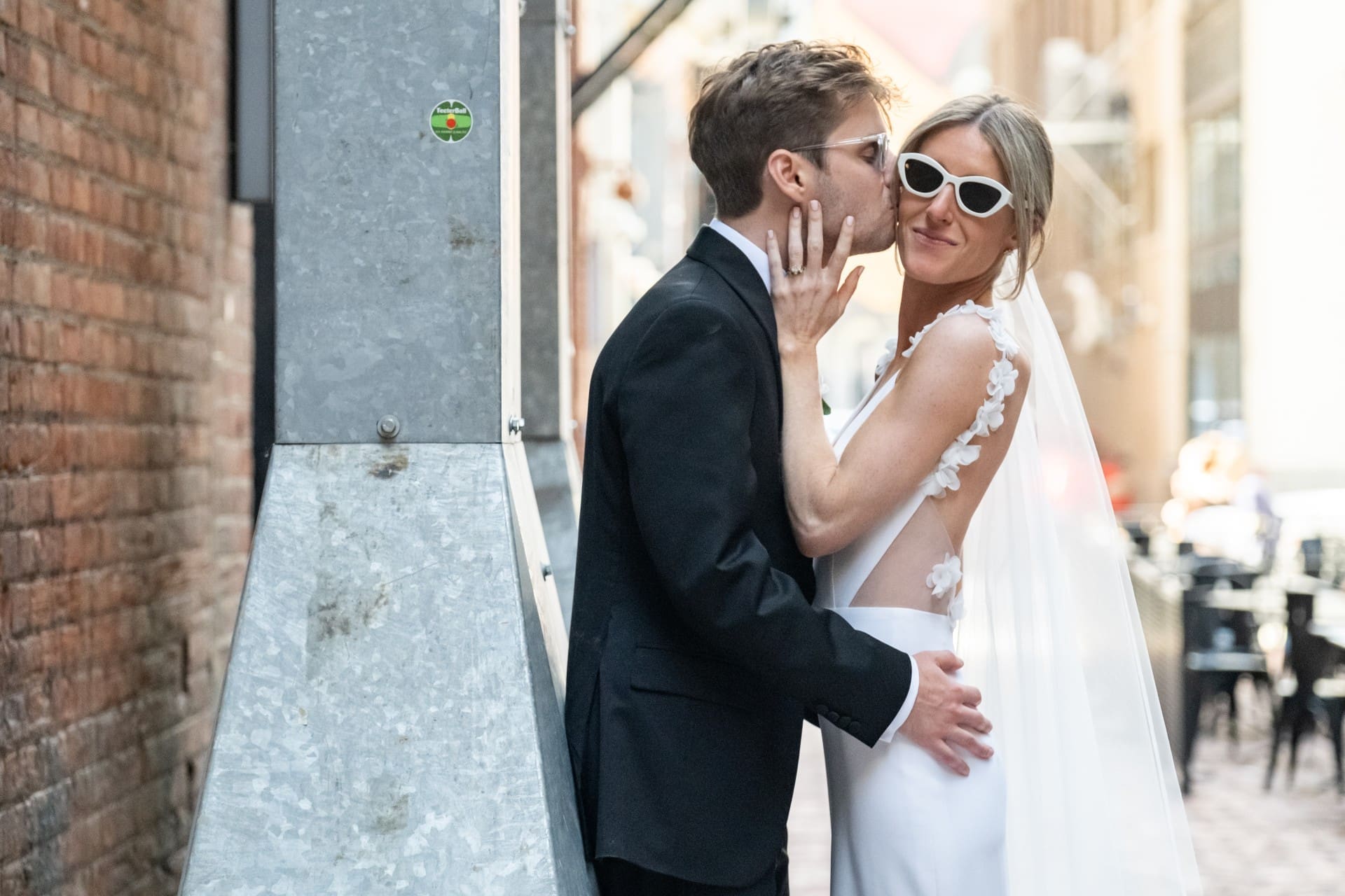Bride and groom sharing a kiss during a romantic wedding portrait in downtown Detroit.