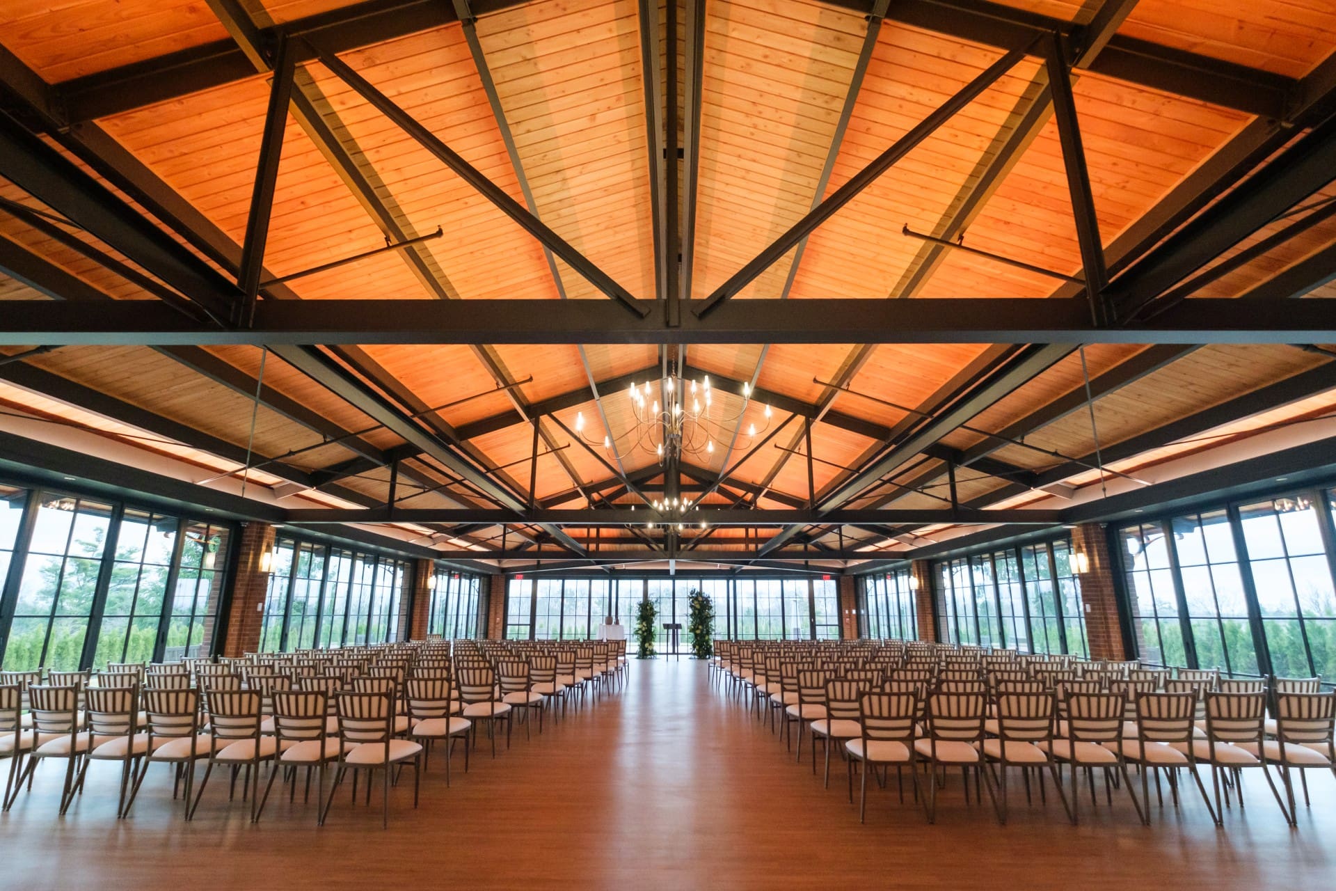 Wedding ceremony space prepared with rows of chairs and natural light