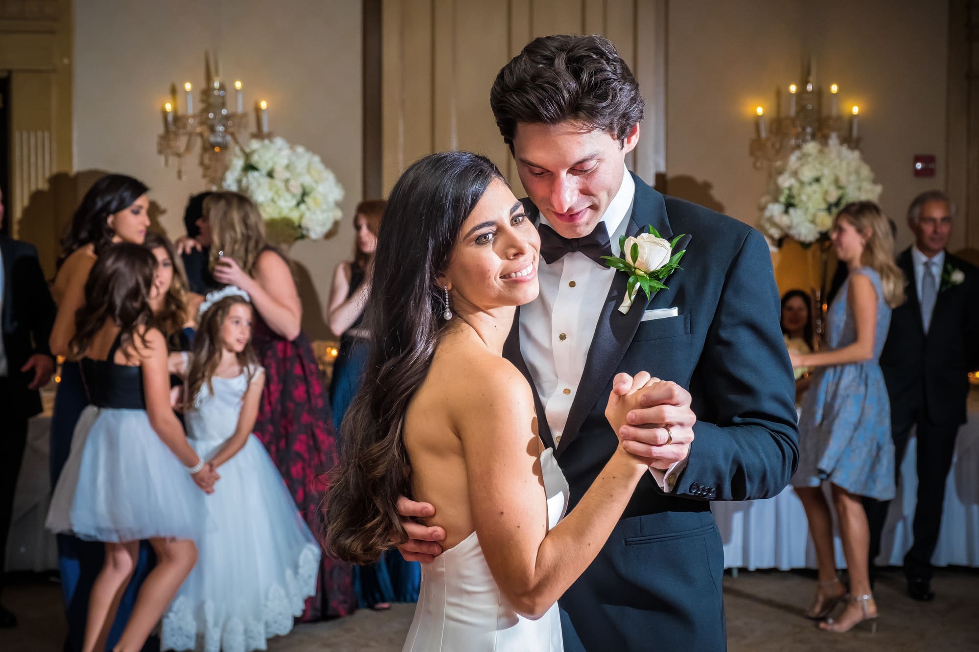 Bride and groom sharing a quiet dance during their Michigan wedding reception captured through documentary wedding photography