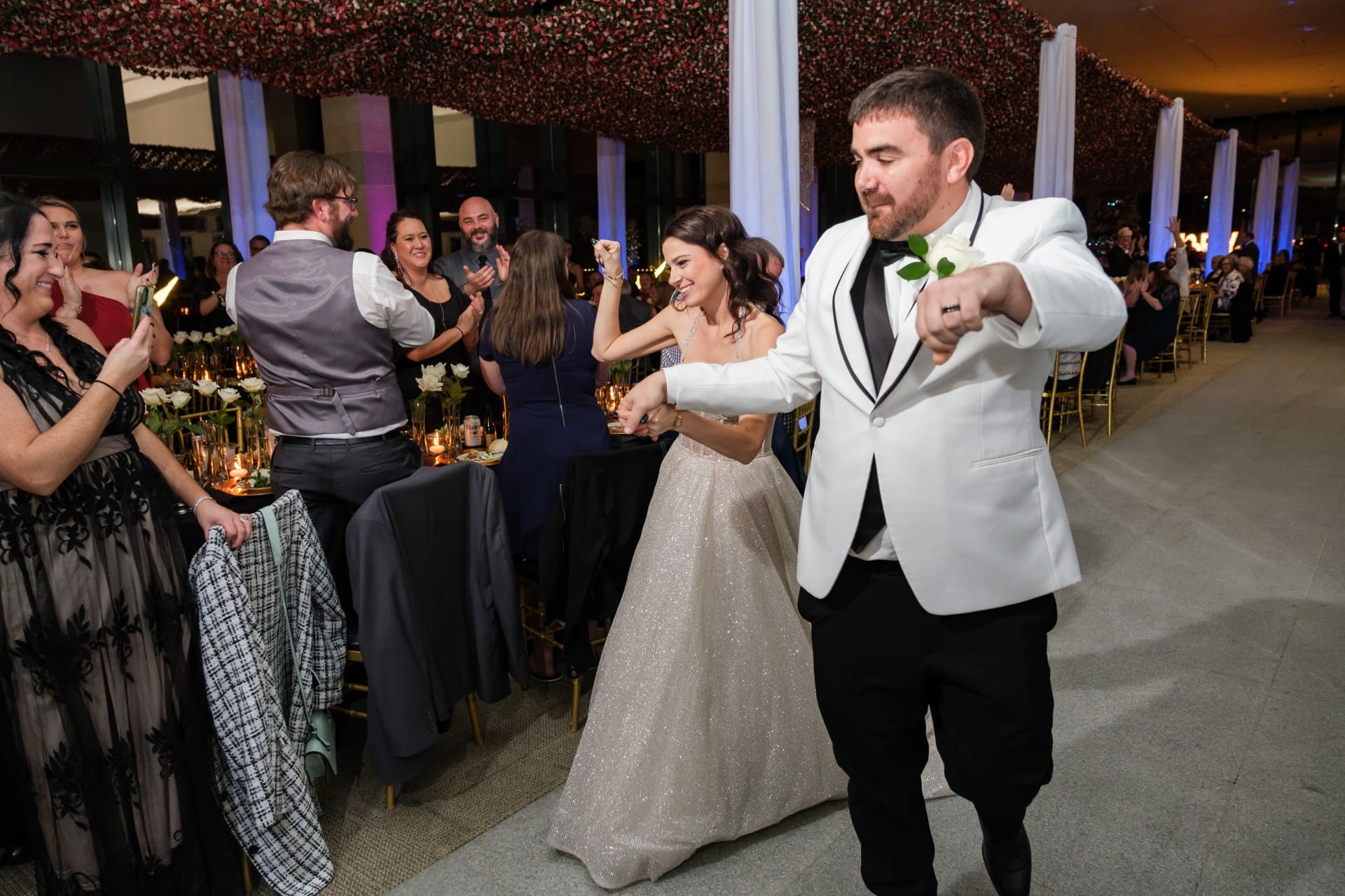 Bride and groom dancing with guests during a Detroit wedding reception