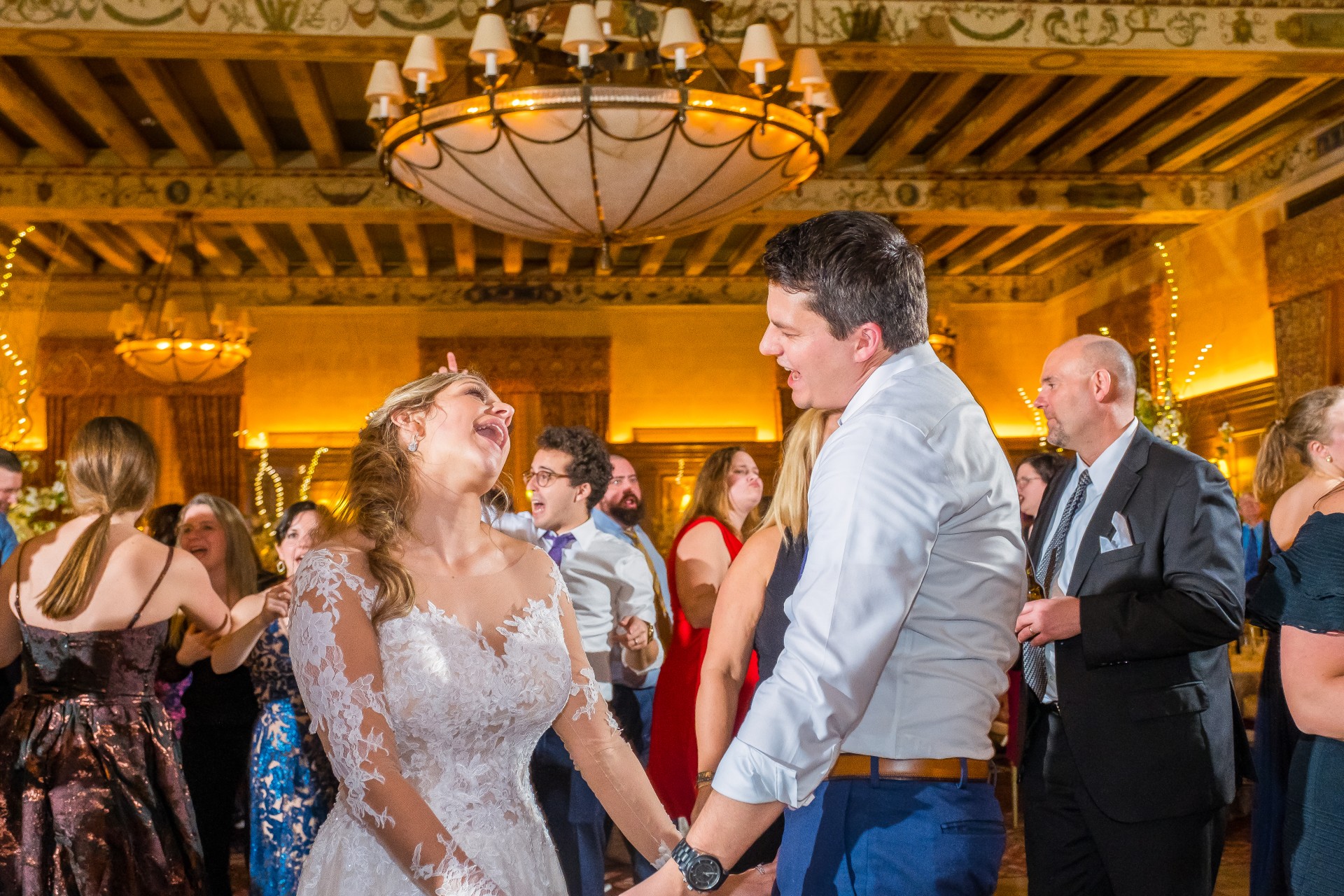 Bride and groom sharing a candid moment with guests during the reception