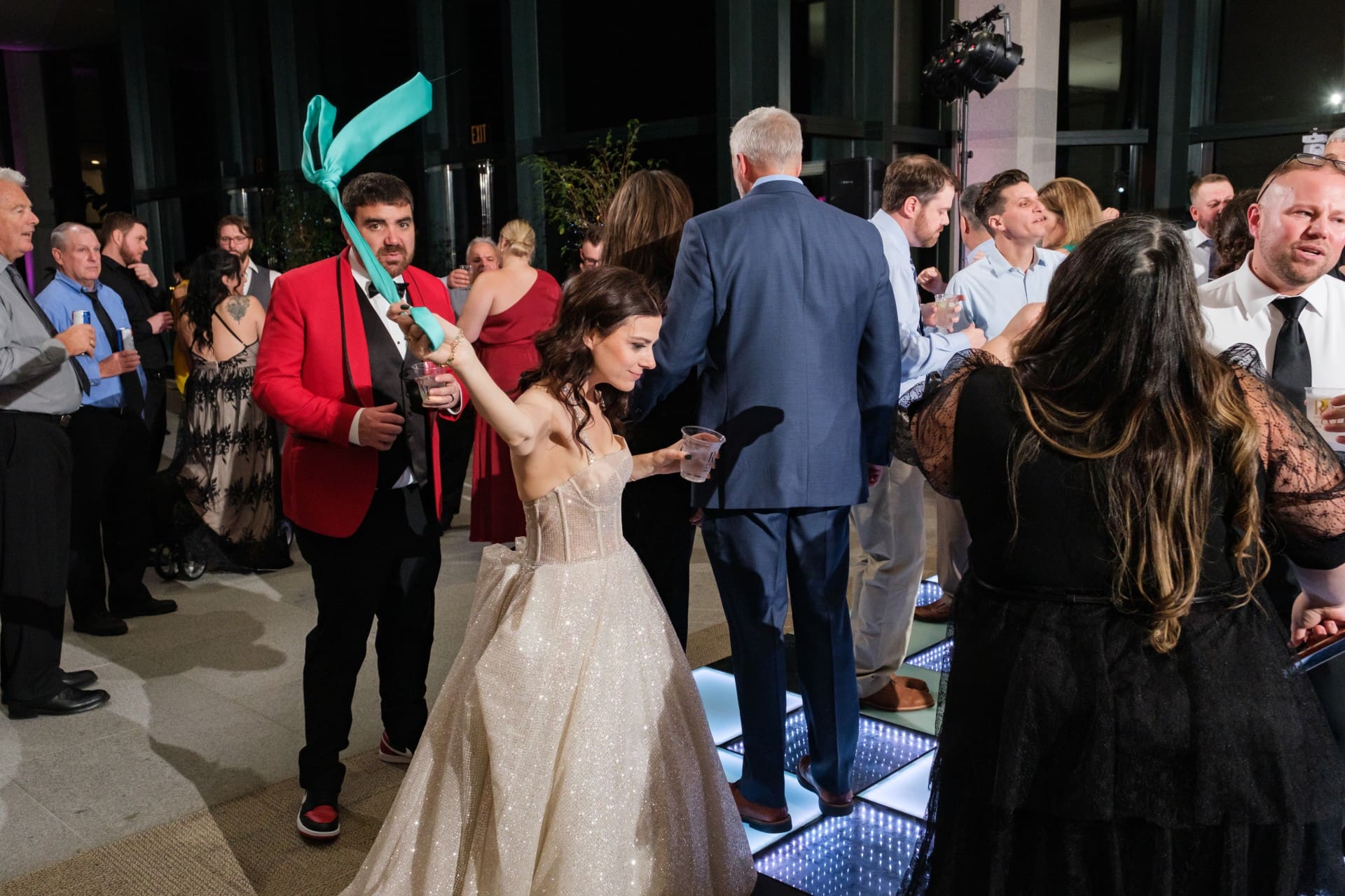 Bride and groom interacting naturally with guests during the wedding reception