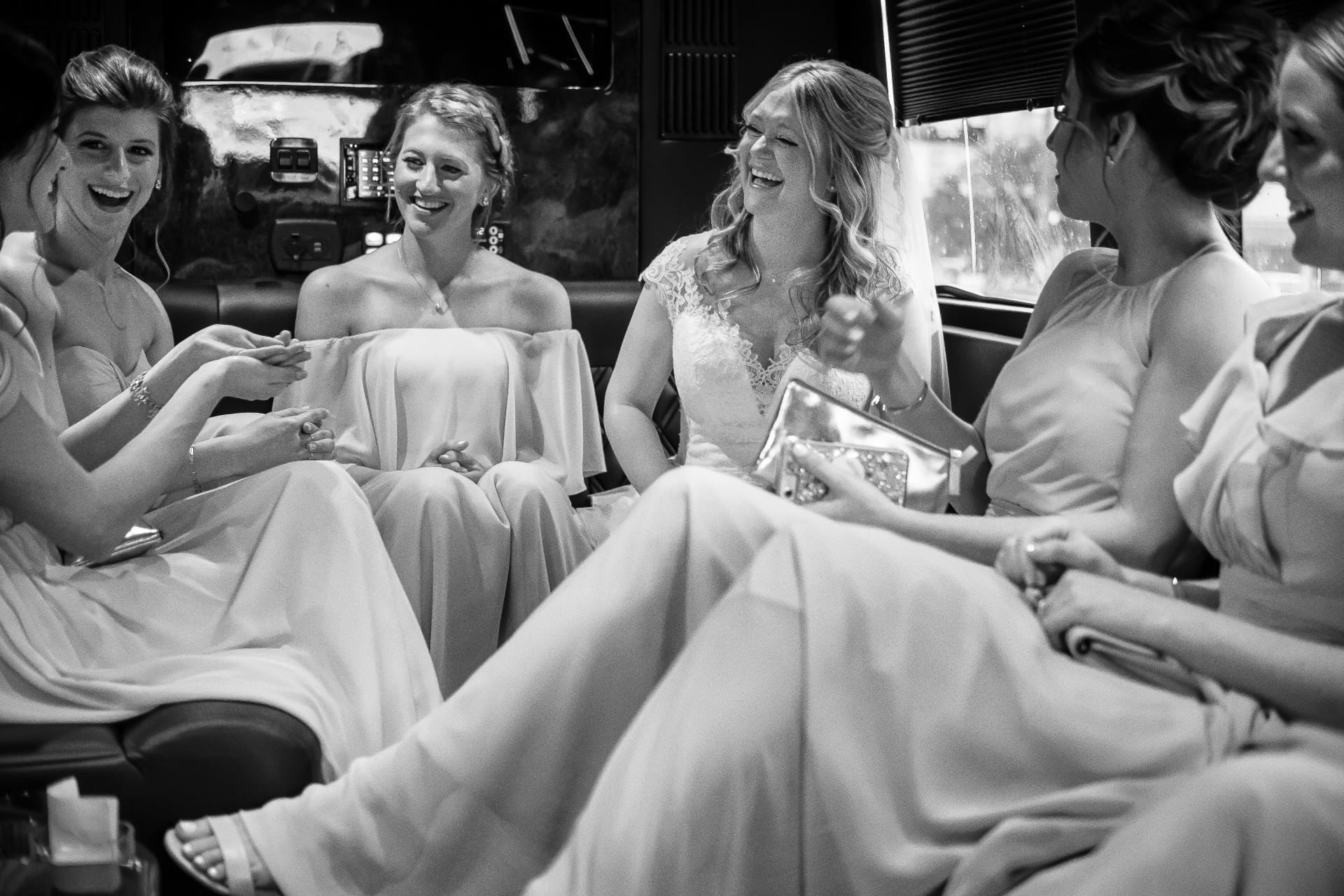 Bride sitting with her bridesmaids during a candid wedding moment