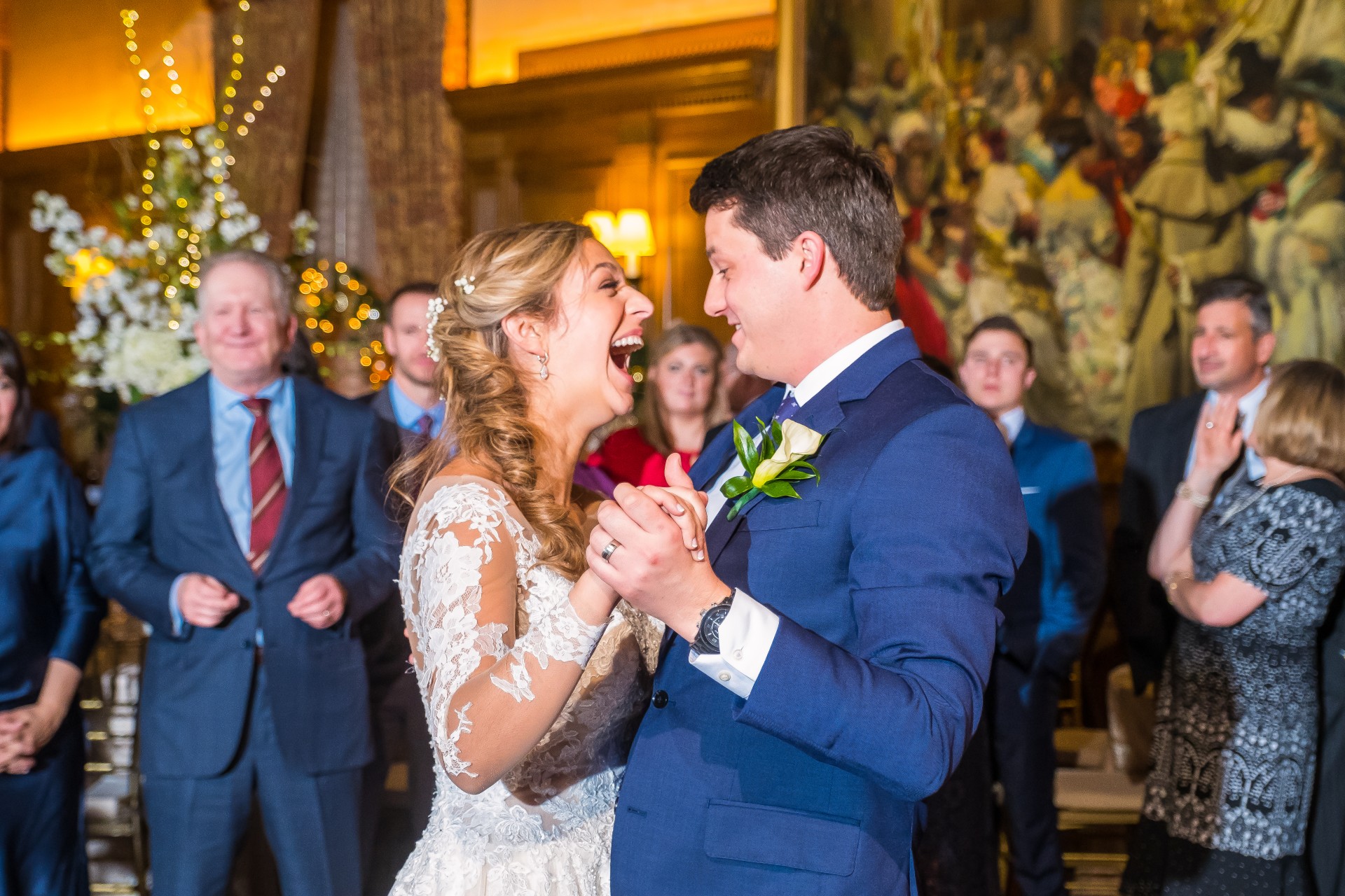 Groom sharing a candid moment with guests during the wedding reception