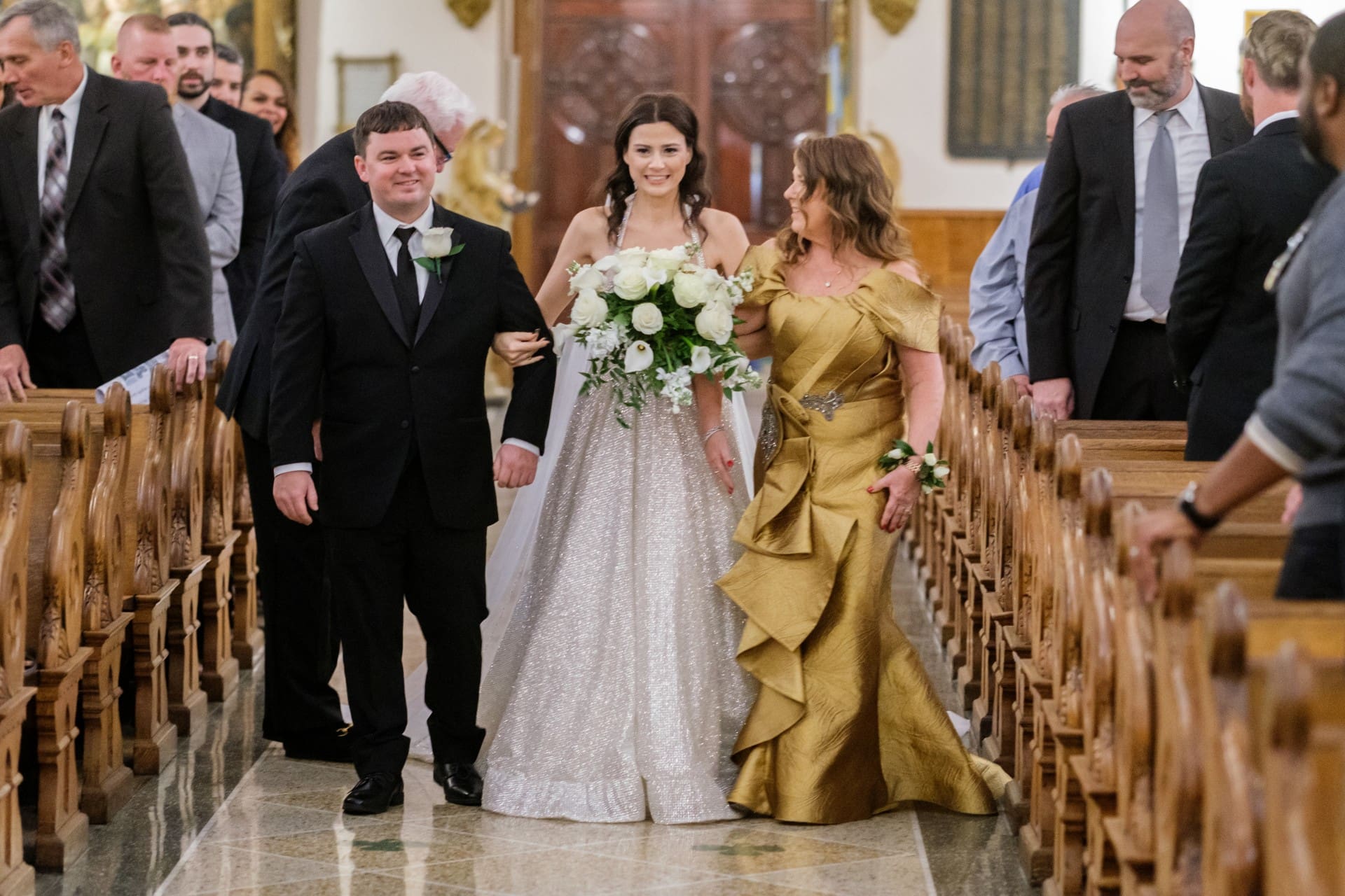 Bride walking with family members during a wedding celebration