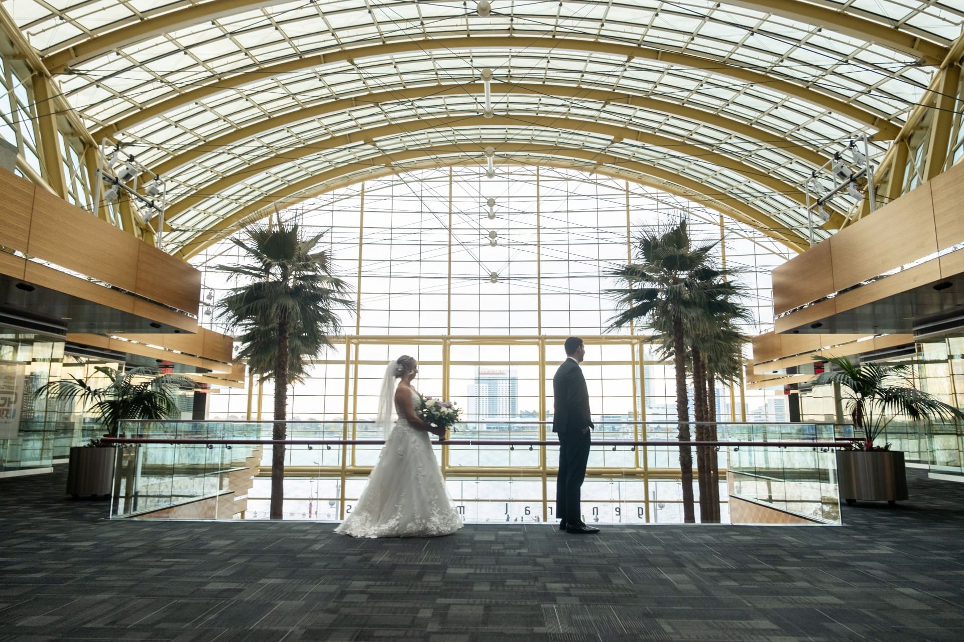 Bride and groom standing apart during a first look at a Detroit wedding venue