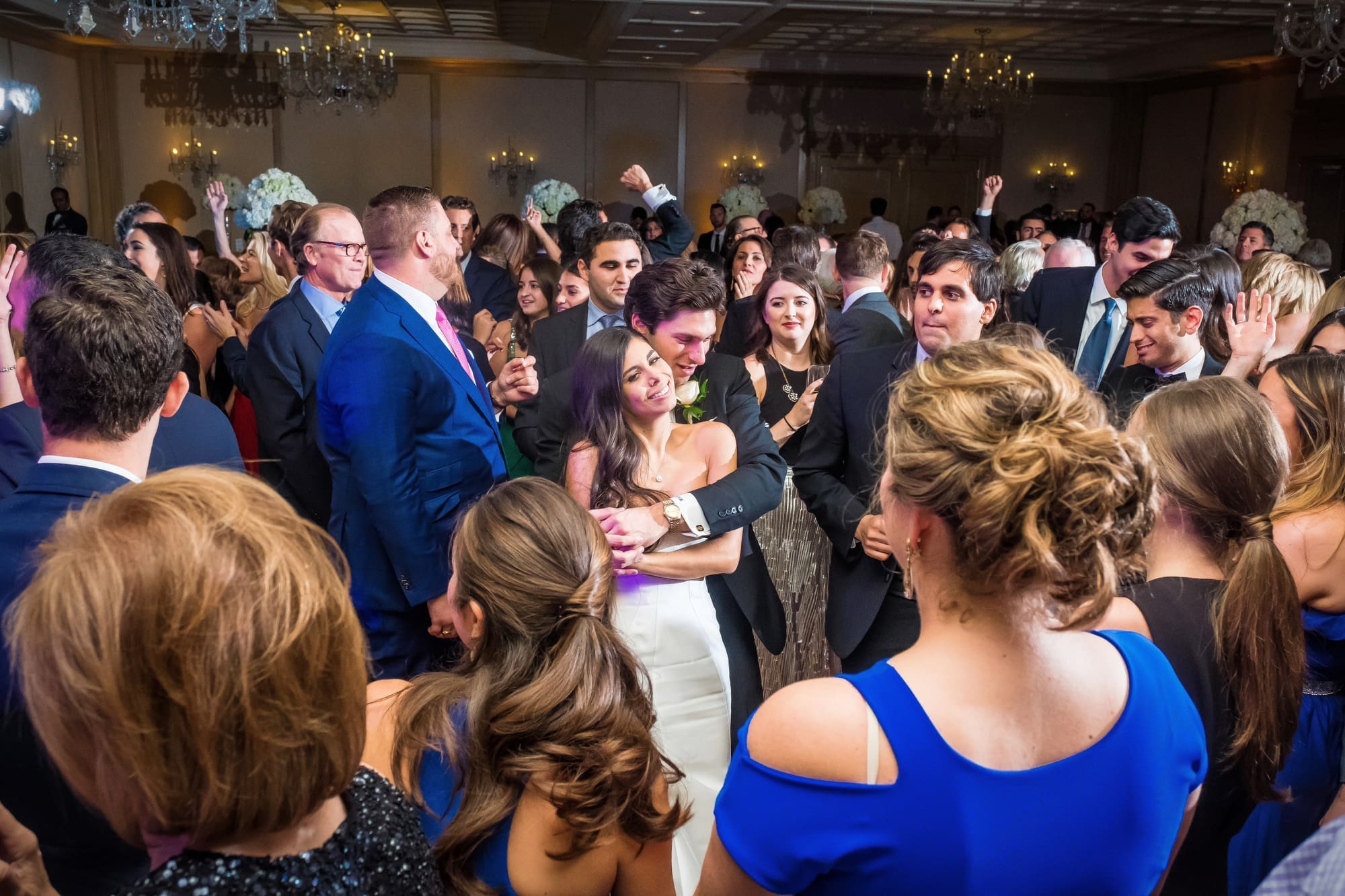 Wedding guests celebrating together during a lively Michigan wedding reception captured through documentary wedding photography