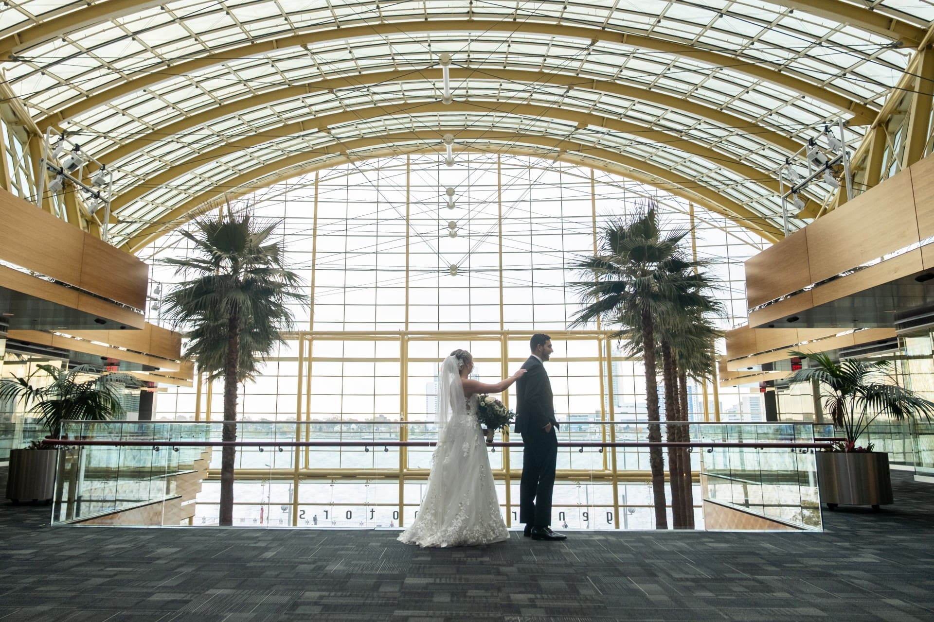 Bride approaching her groom during a first look at a Detroit wedding venue