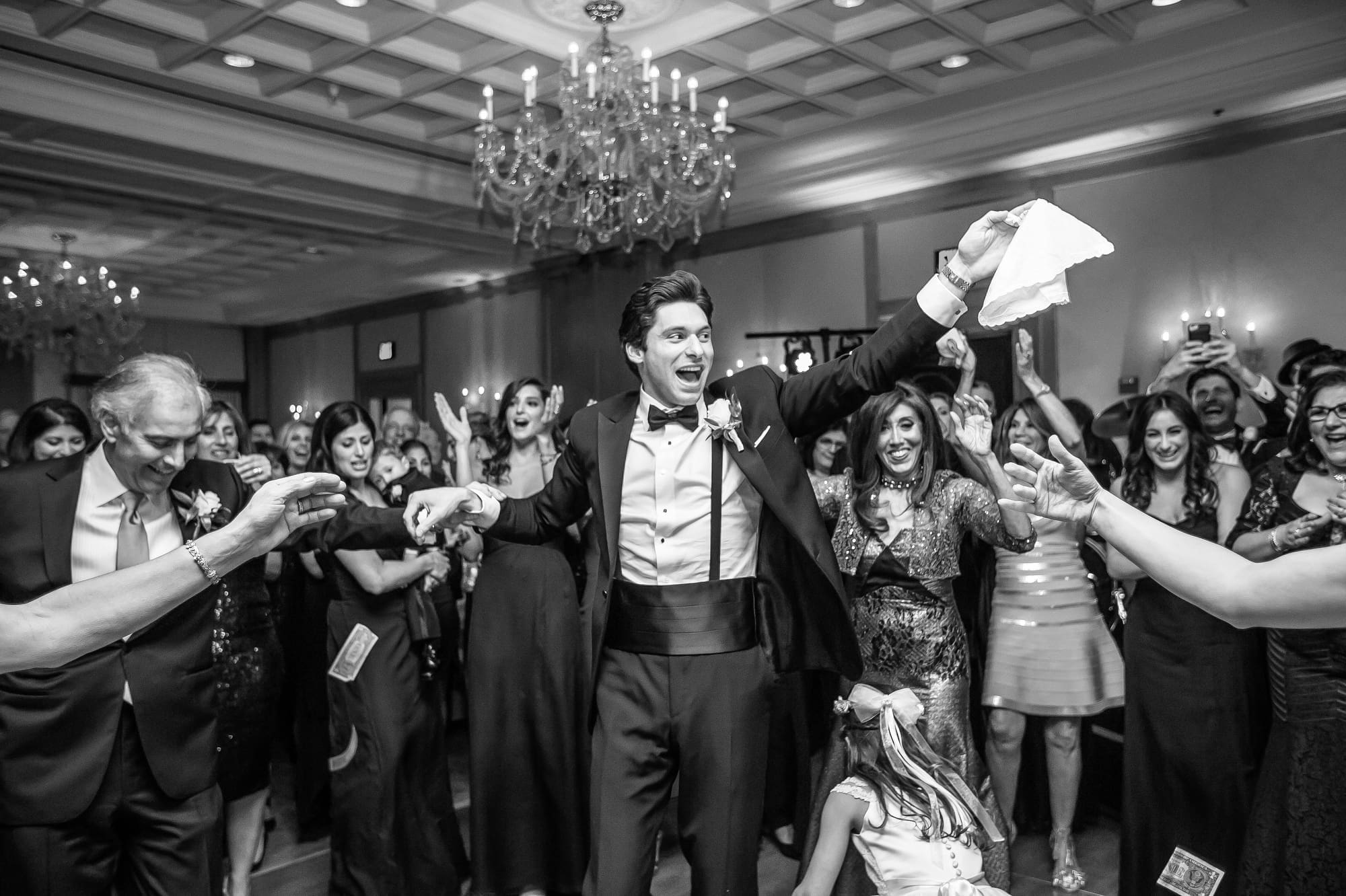 Guests celebrating on the dance floor during a lively Michigan wedding reception captured through documentary wedding photography