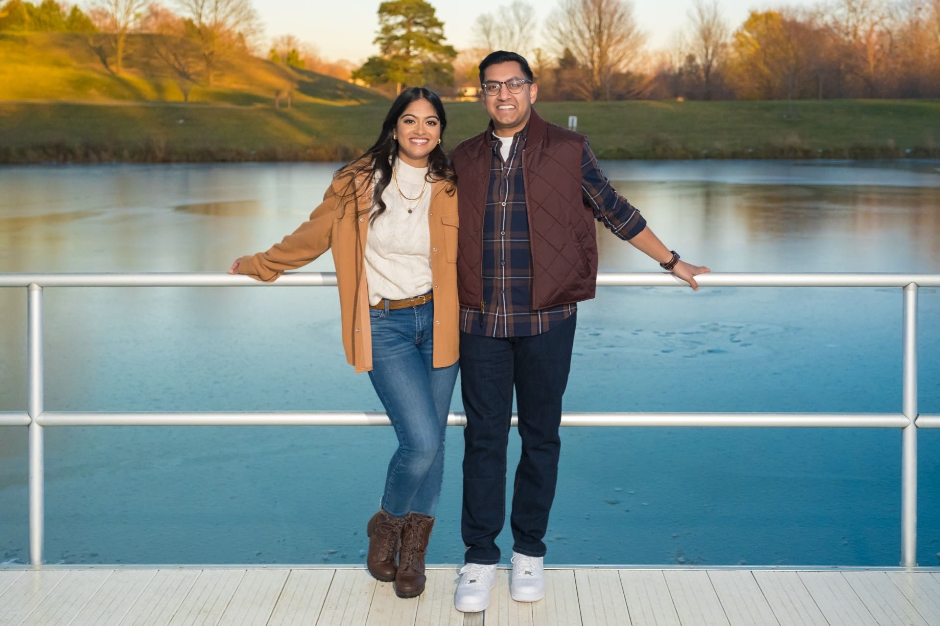 Couple standing together beside a frozen pond