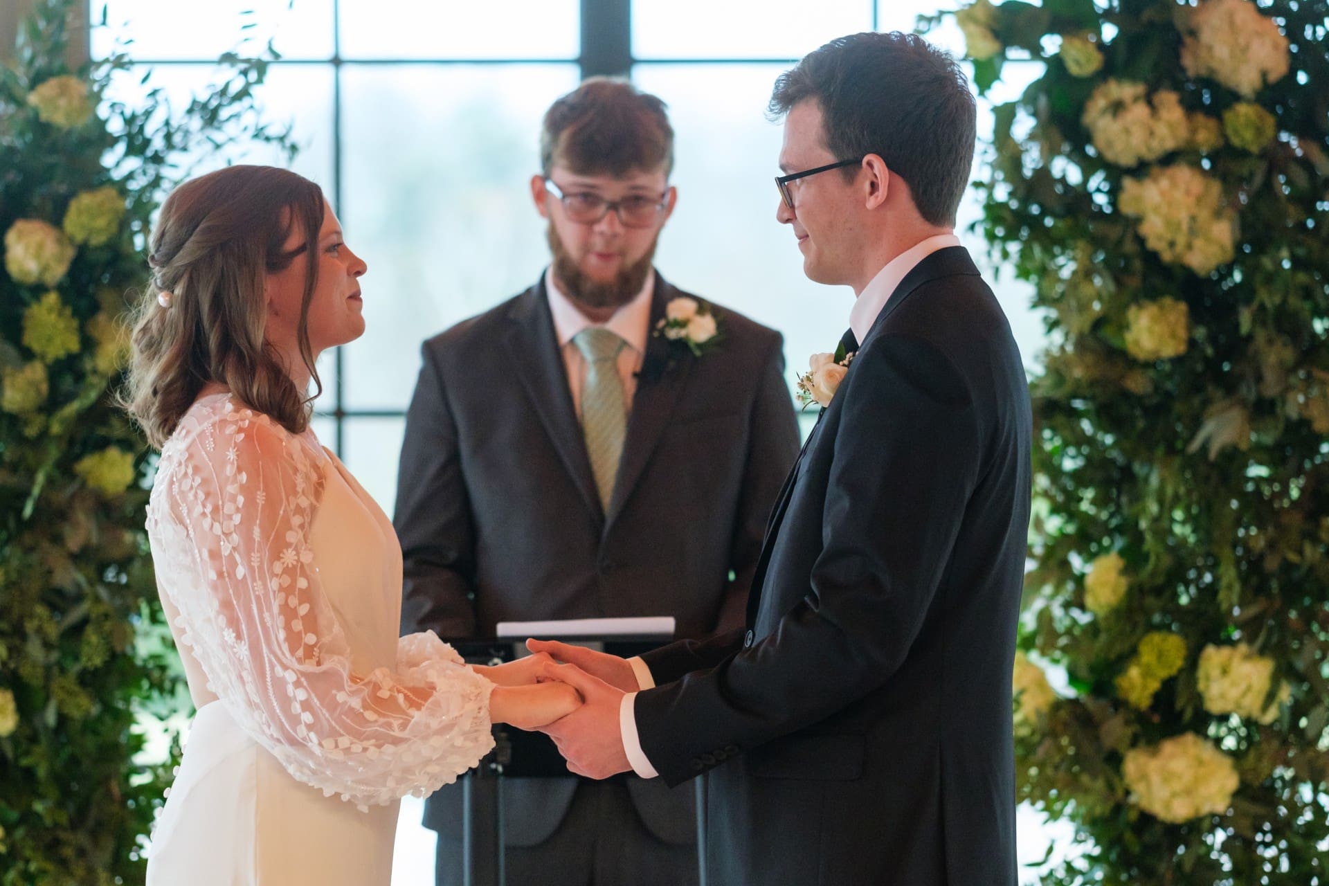 Andrew and Rachel exchanging vows during their St. John’s Resort wedding ceremony in Plymouth, Michigan
