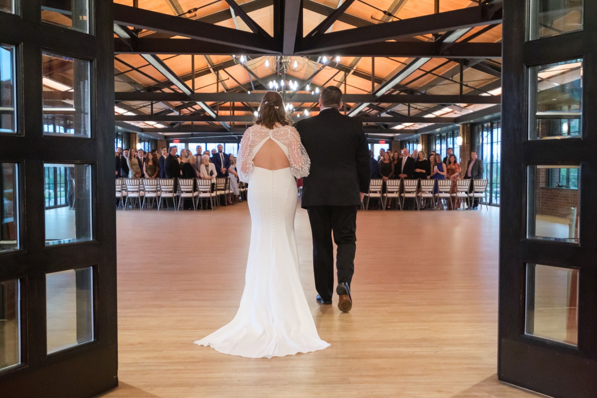 Andrew and Rachel walking into their wedding reception at St. John’s Resort in Plymouth, Michigan