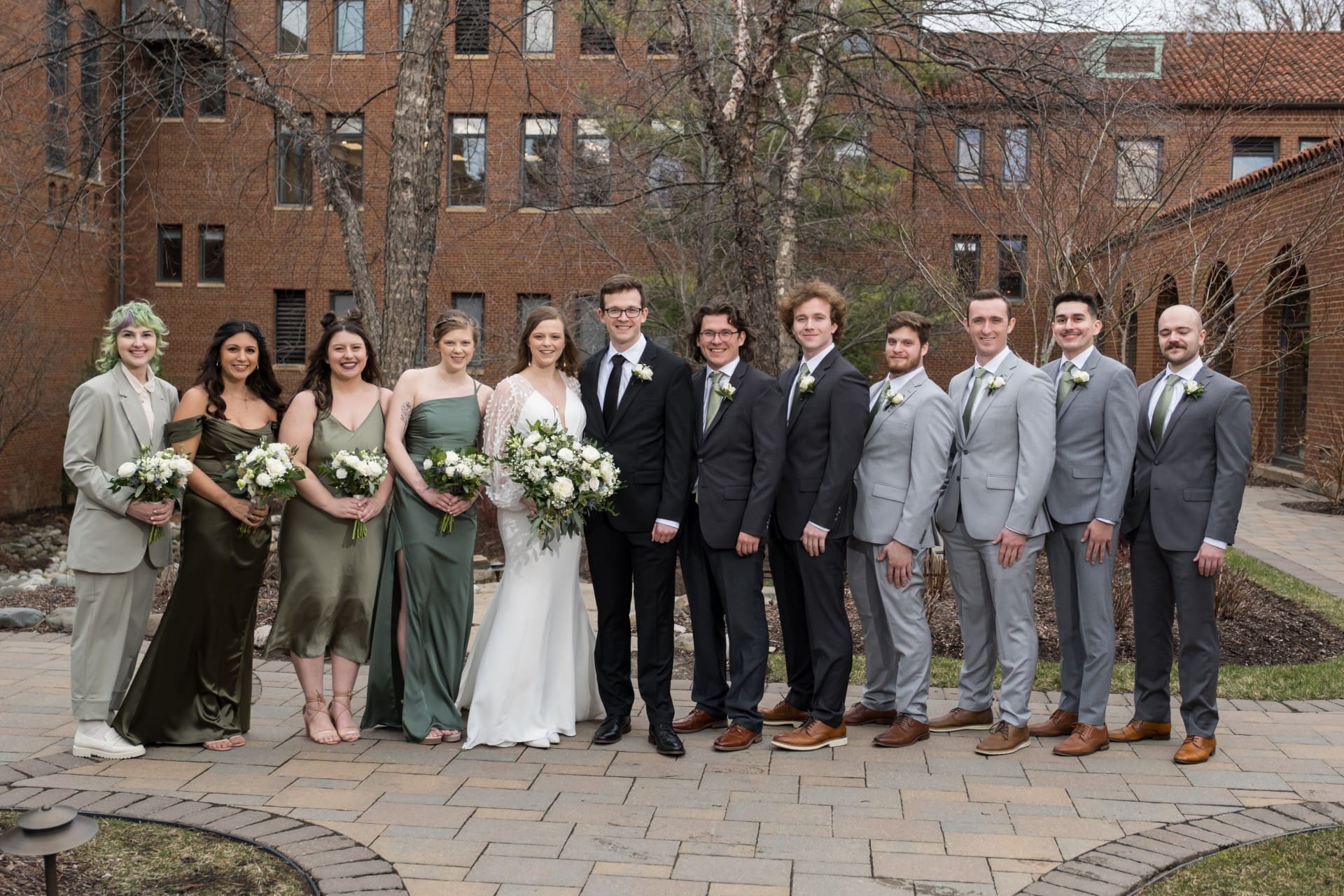 Andrew and Rachel with their wedding party outdoors