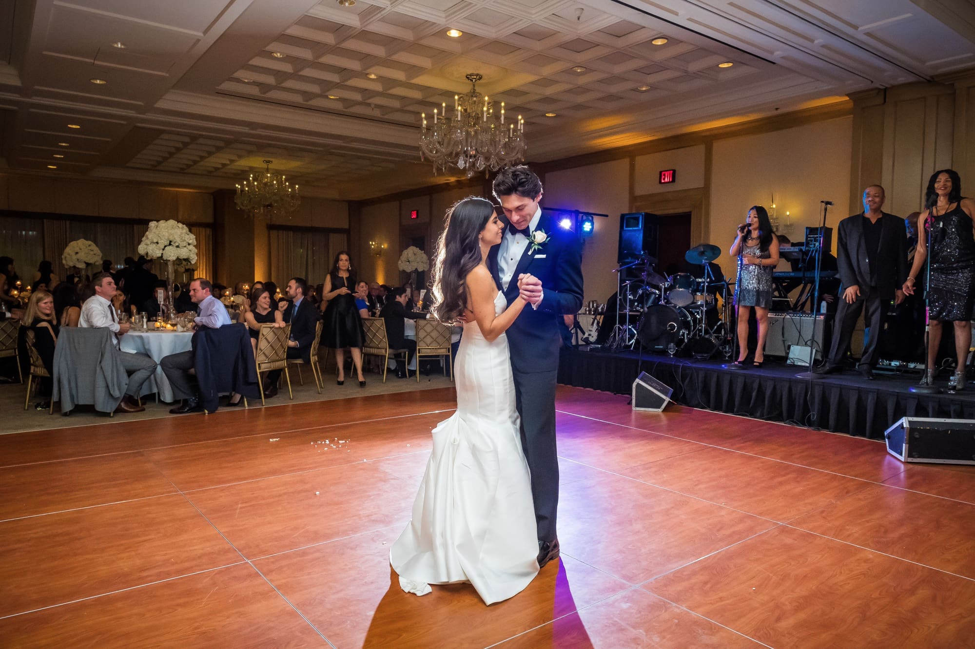 Bride and groom sharing their first dance during a Michigan wedding reception captured through documentary wedding photography