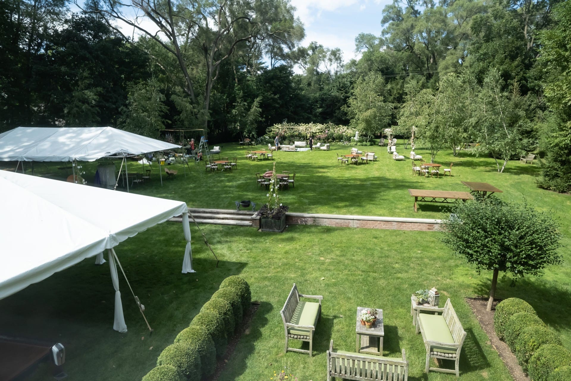 Bloomfield Hills wedding reception area with white tents, garden seating, and lush greenery