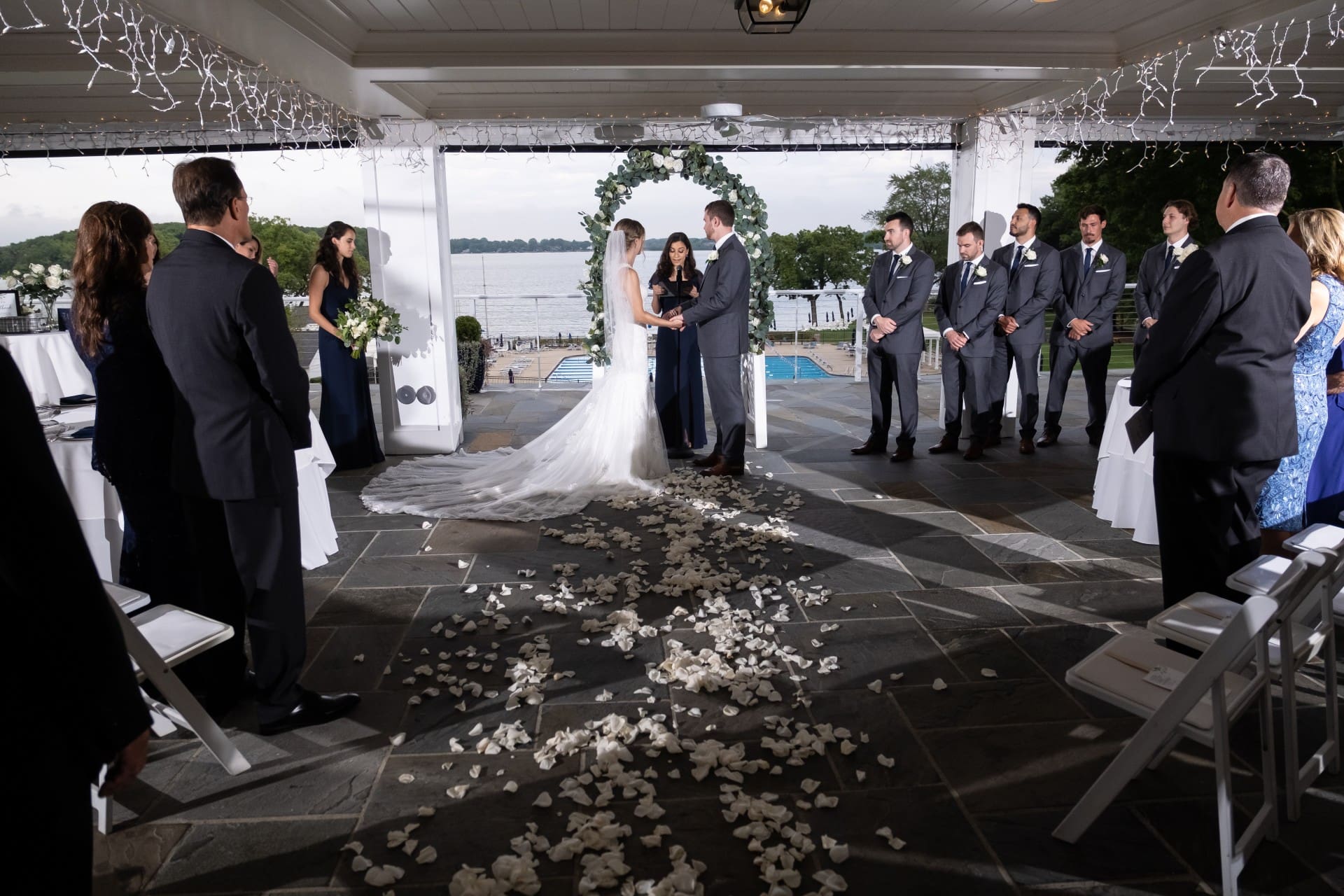 Orchard Lake wedding ceremony with bride and groom at a lakeside venue surrounded by their wedding party