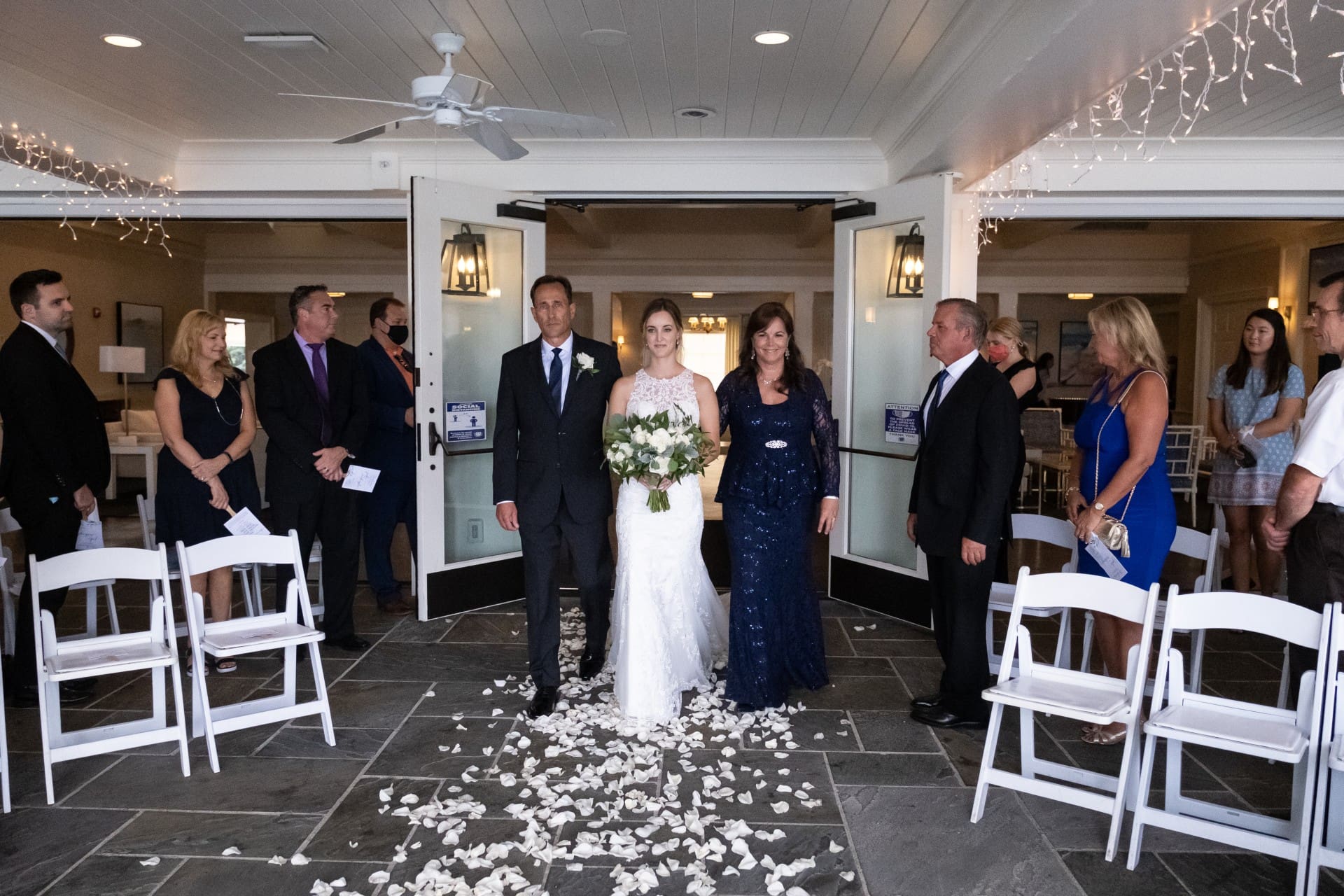 Orchard Lake wedding couple walking down the aisle with family and guests gathered for the ceremony